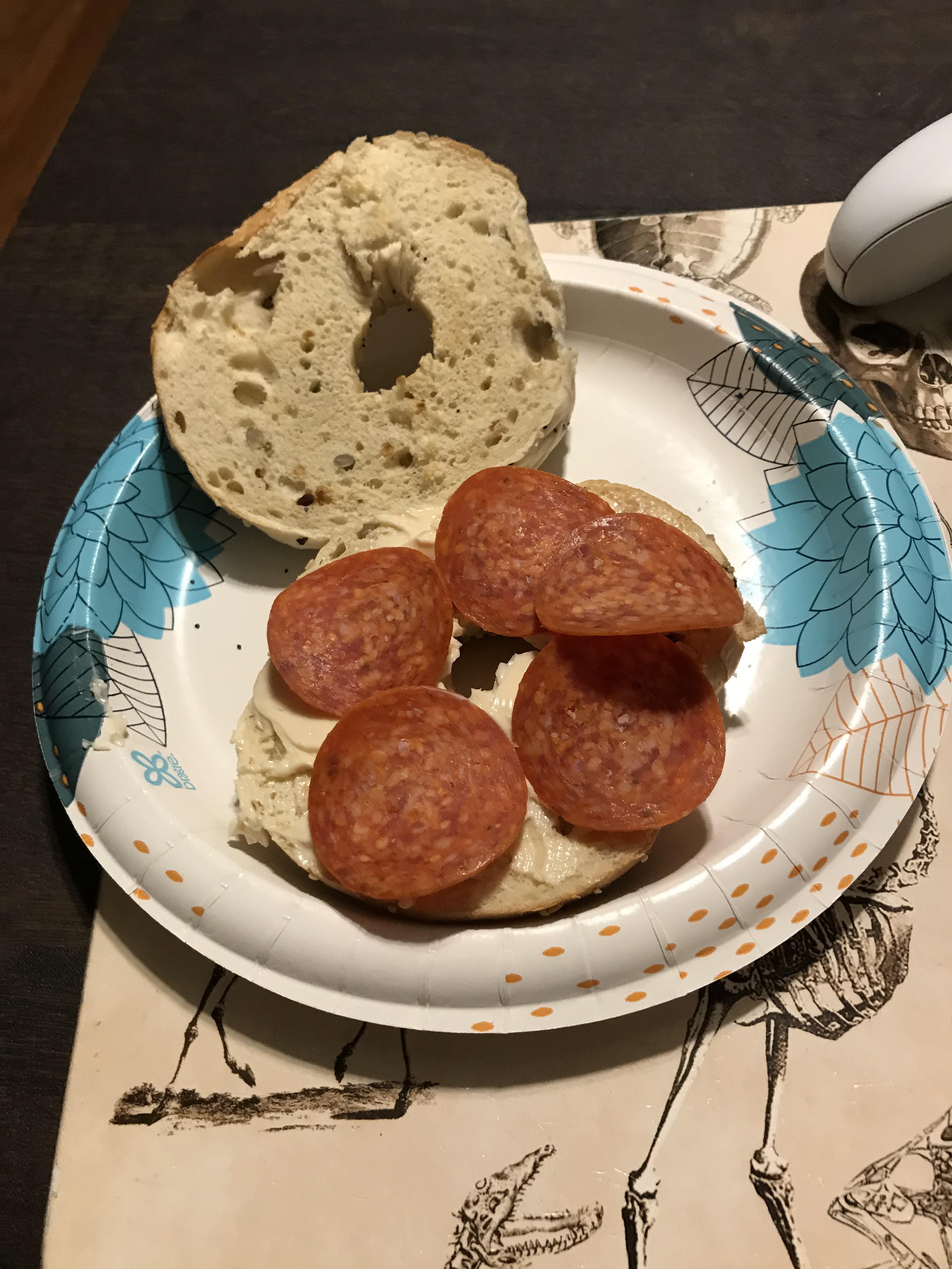 Pepperoni and Laughing Cow spread on a toasted everything bagel r
