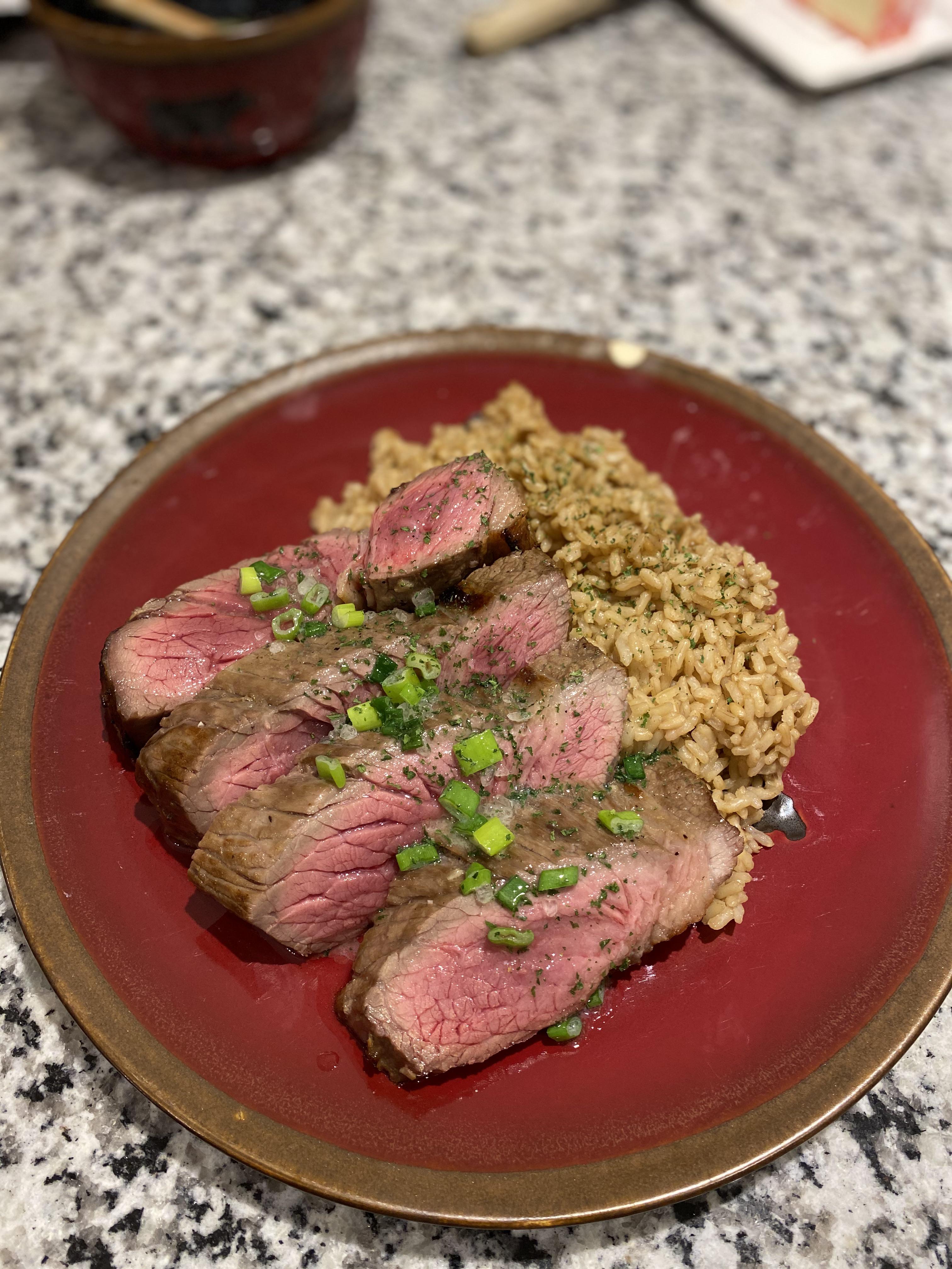 London broil with an herb butter sauce and olive oil brown rice. r