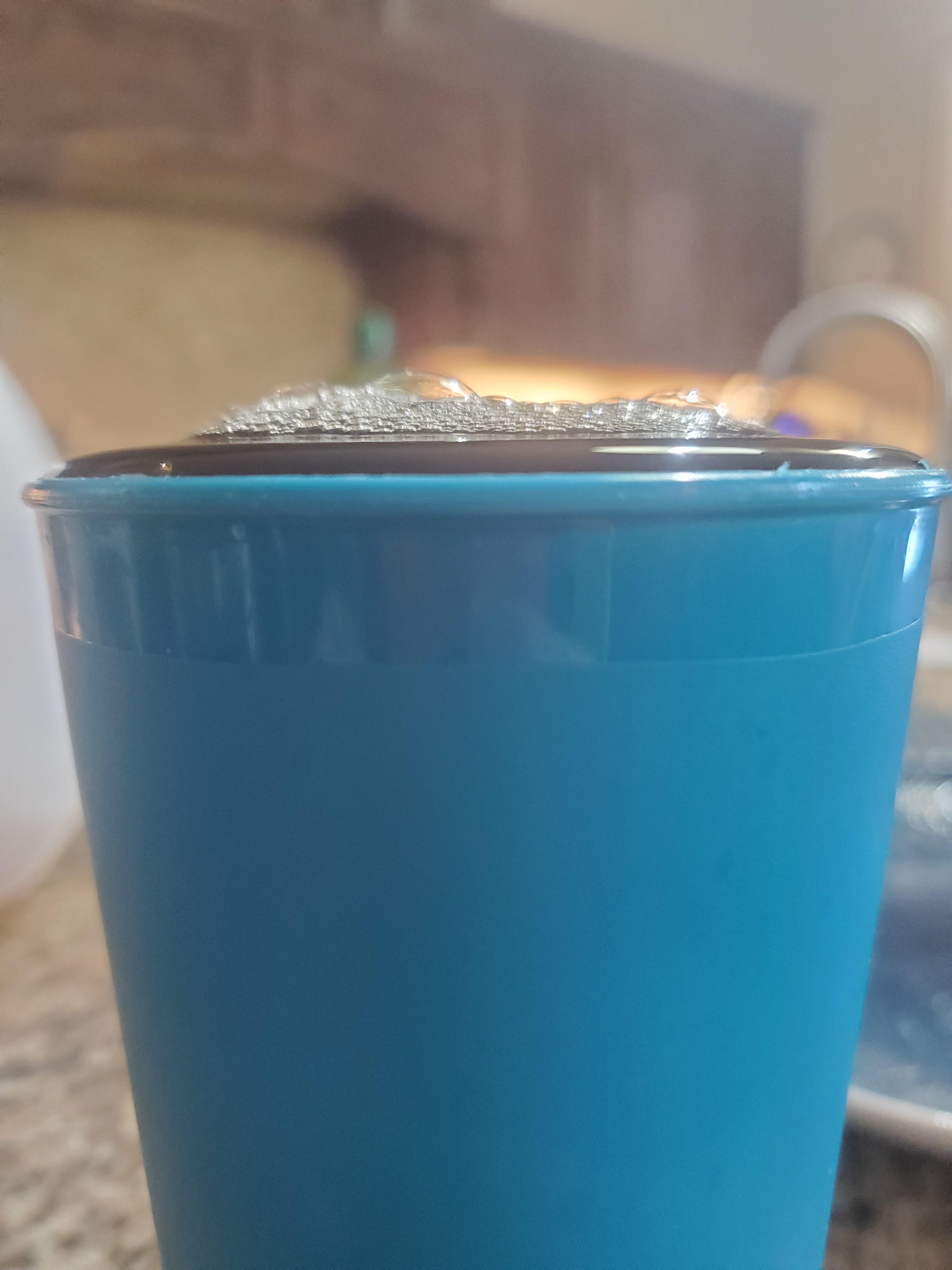 Surface tension keeping a cup of tea from spilling over. r