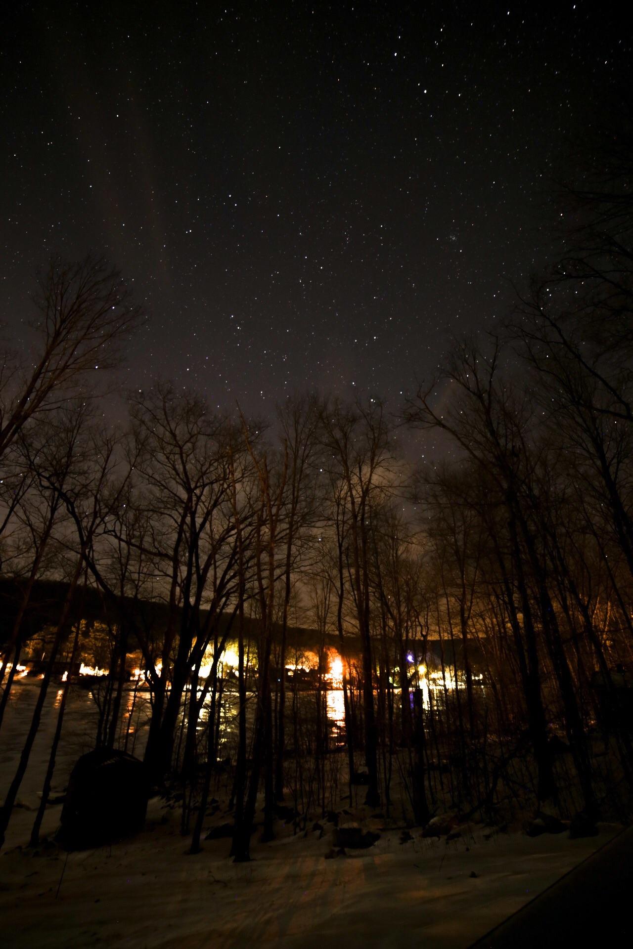 Frozen Deep Creek Lake under clouds and stars r/maryland