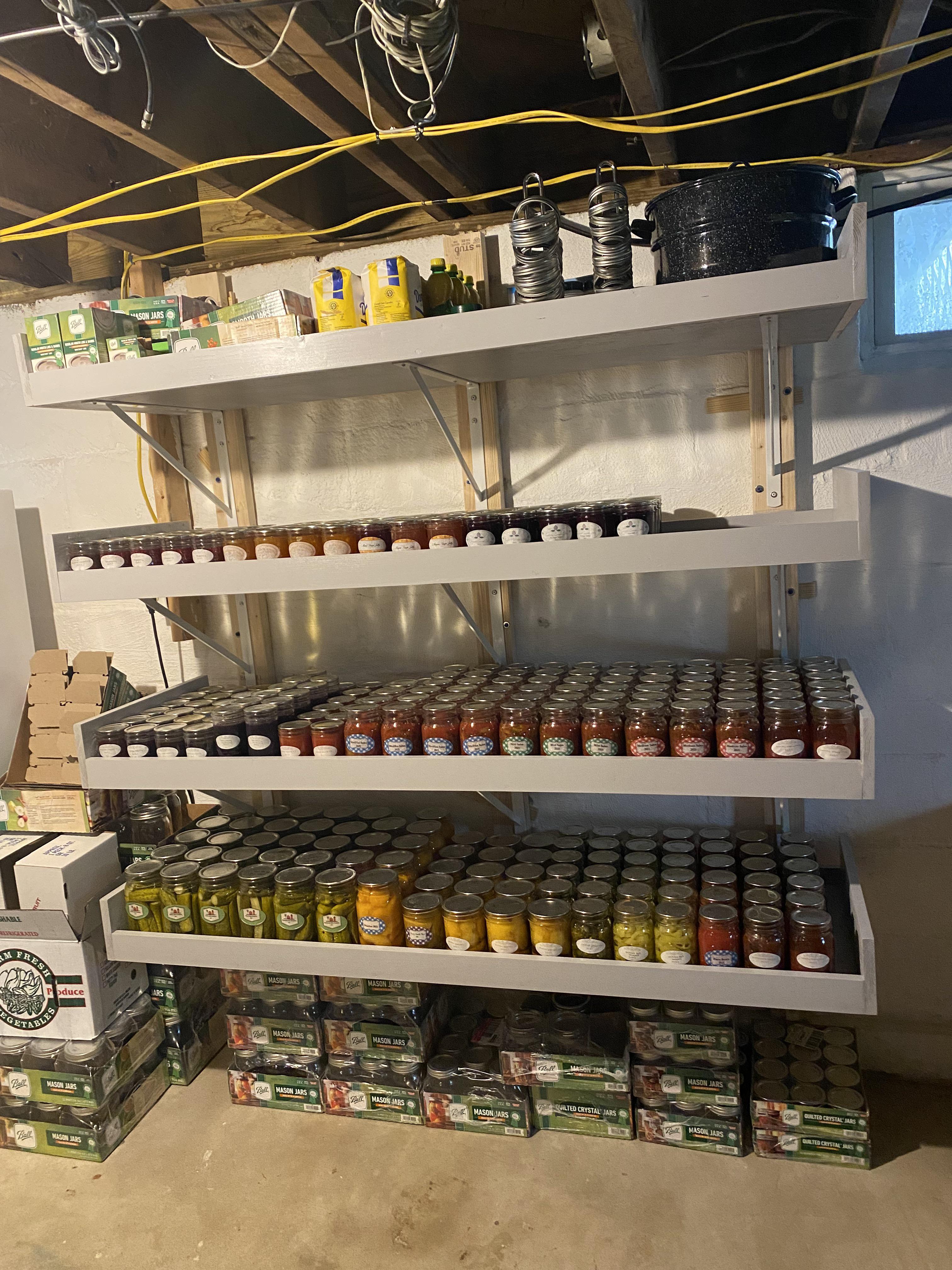 My husband built these shelves for all the canning I have done this year r/Canning