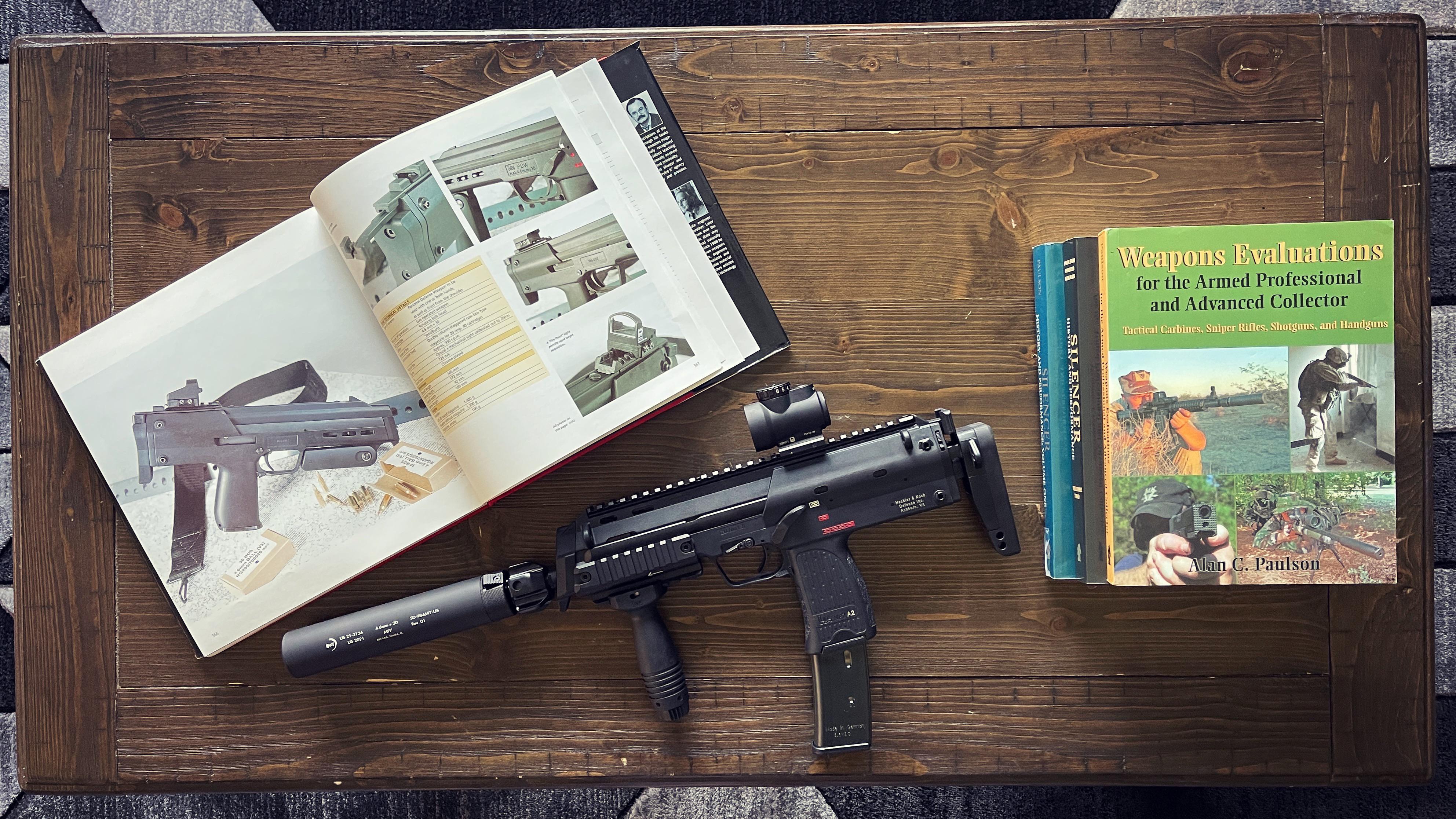 MP7 and some coffee table reading materials. r/guns