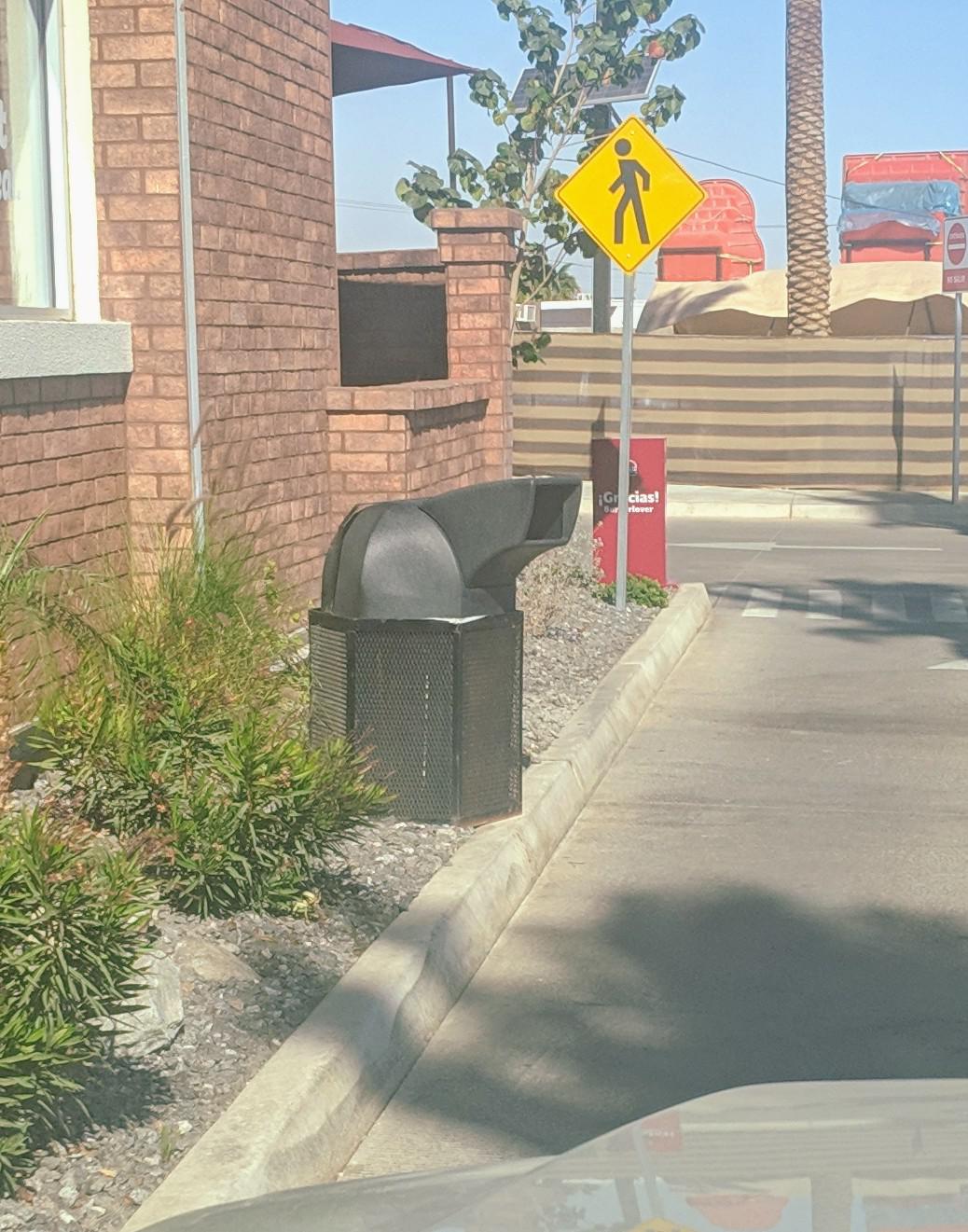 This trash can in a drivethru has an extension so you can throw trash