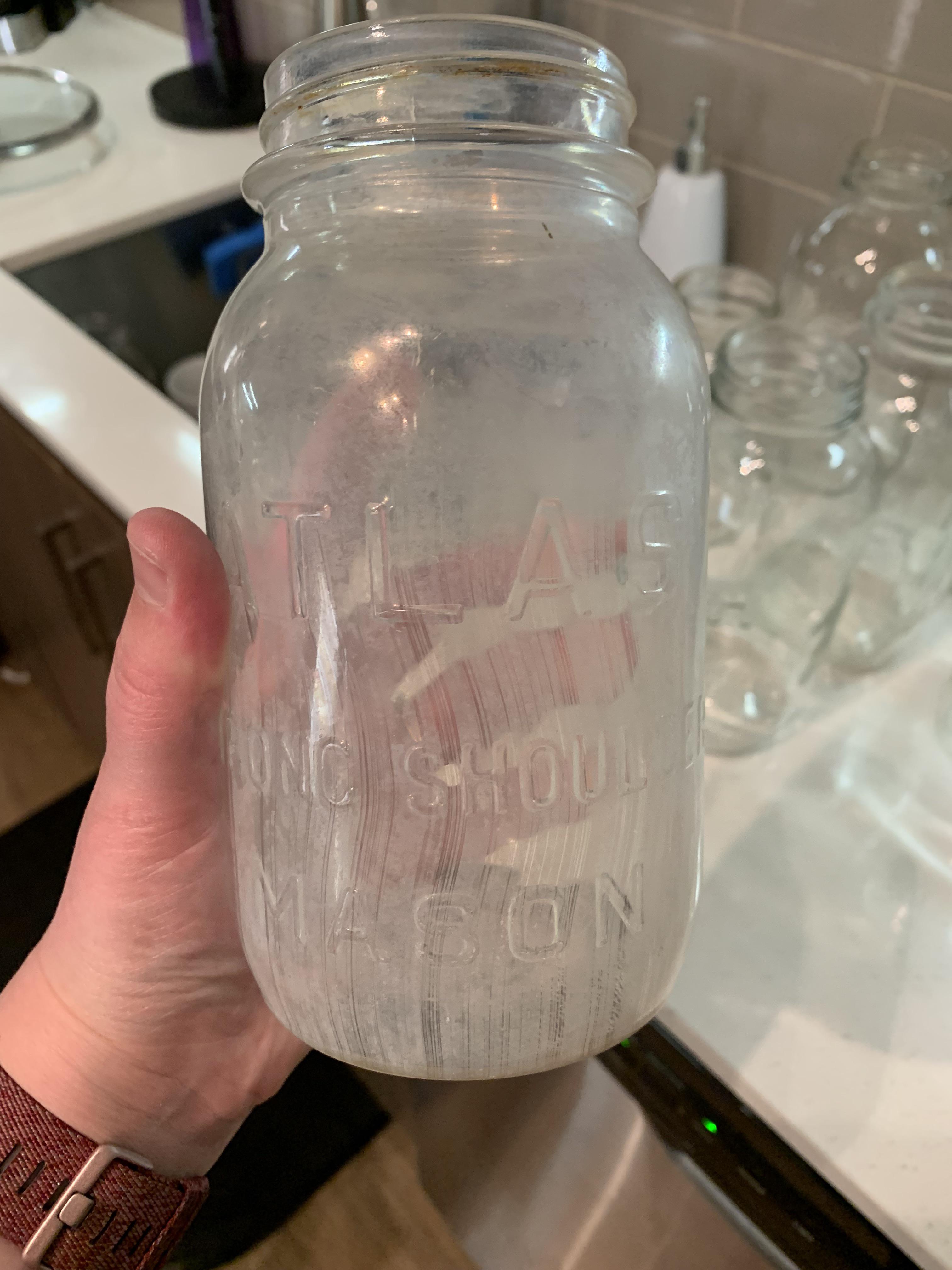 How to clean this mason jar? I was given a lot of jars and noticed that