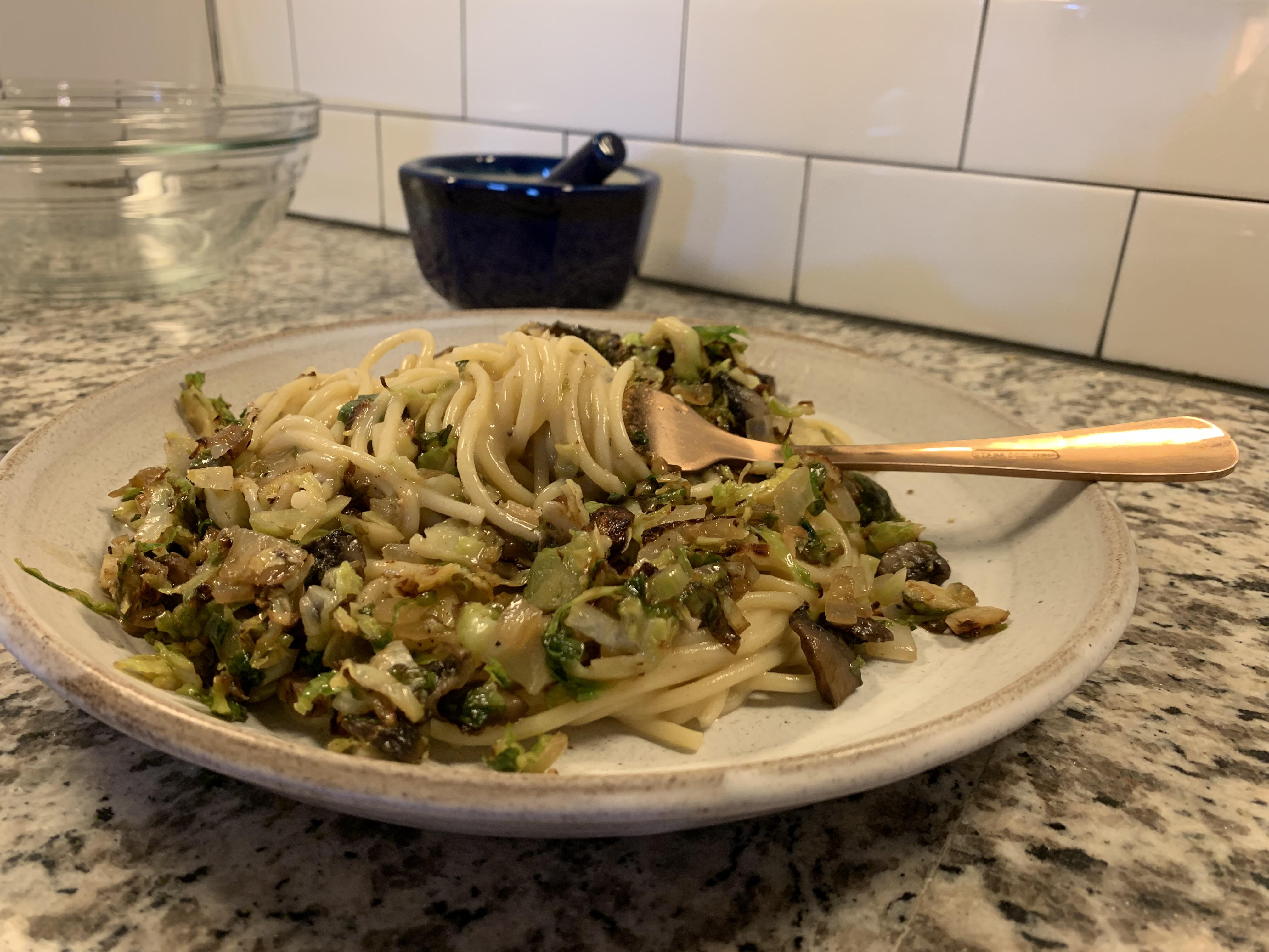 Shaved Brussels sprout and mushroom pasta in creamy coconut alfredo sauce. No wet cashews