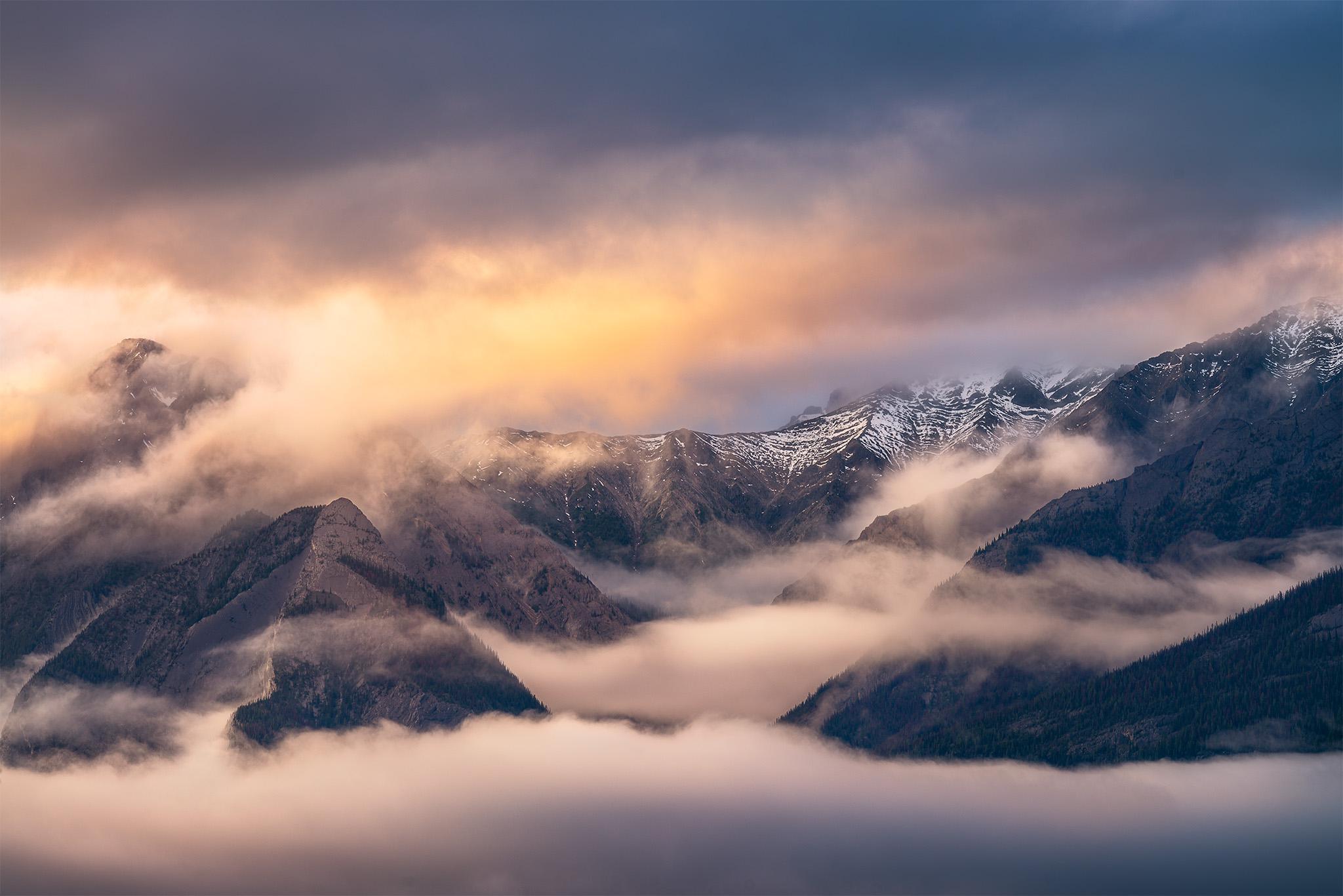 Evening light over massive mountain peaks in Jasper National Park