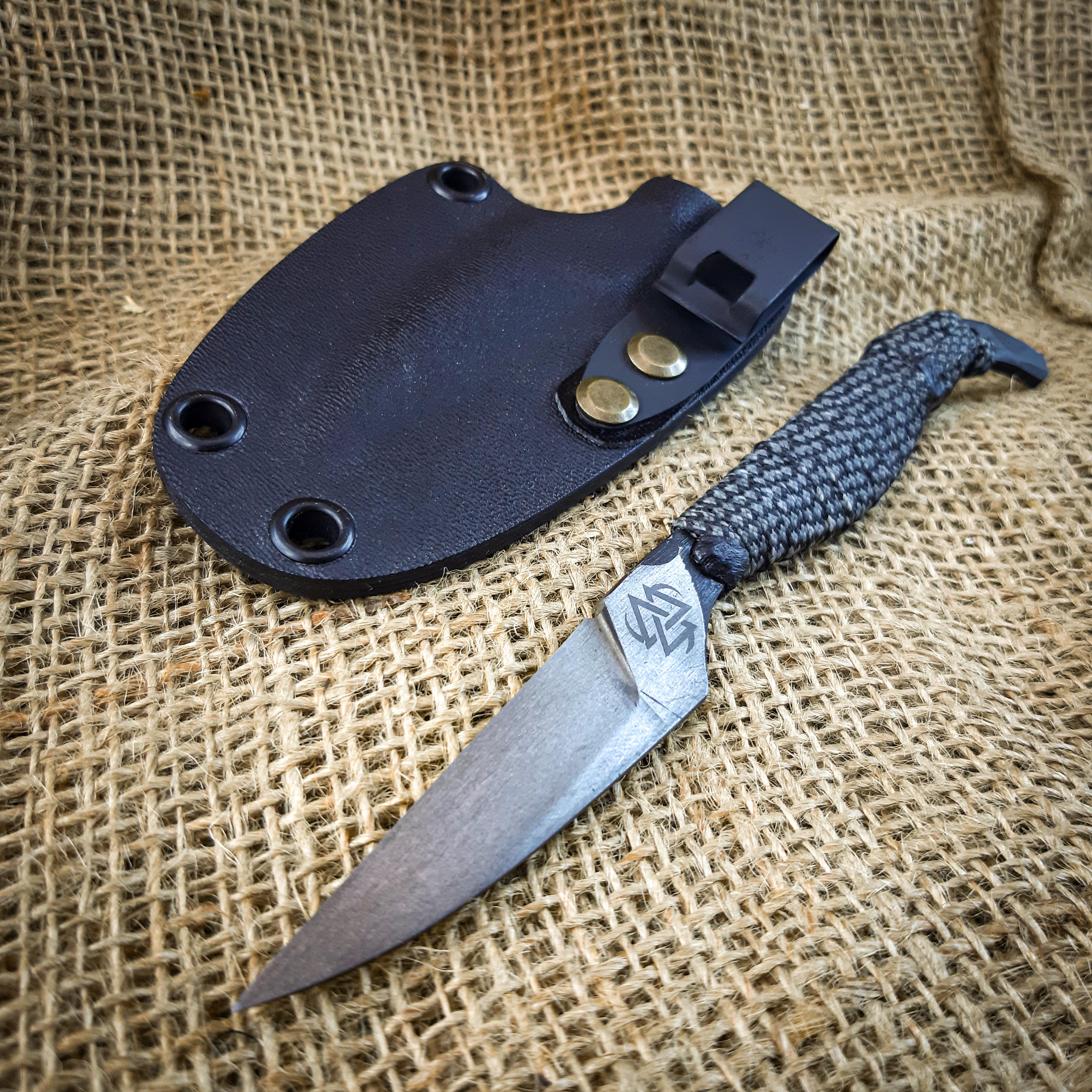 My latest reverse spike knife. D2 Steel, resin stabilized paracord wrap and kydex sheath with