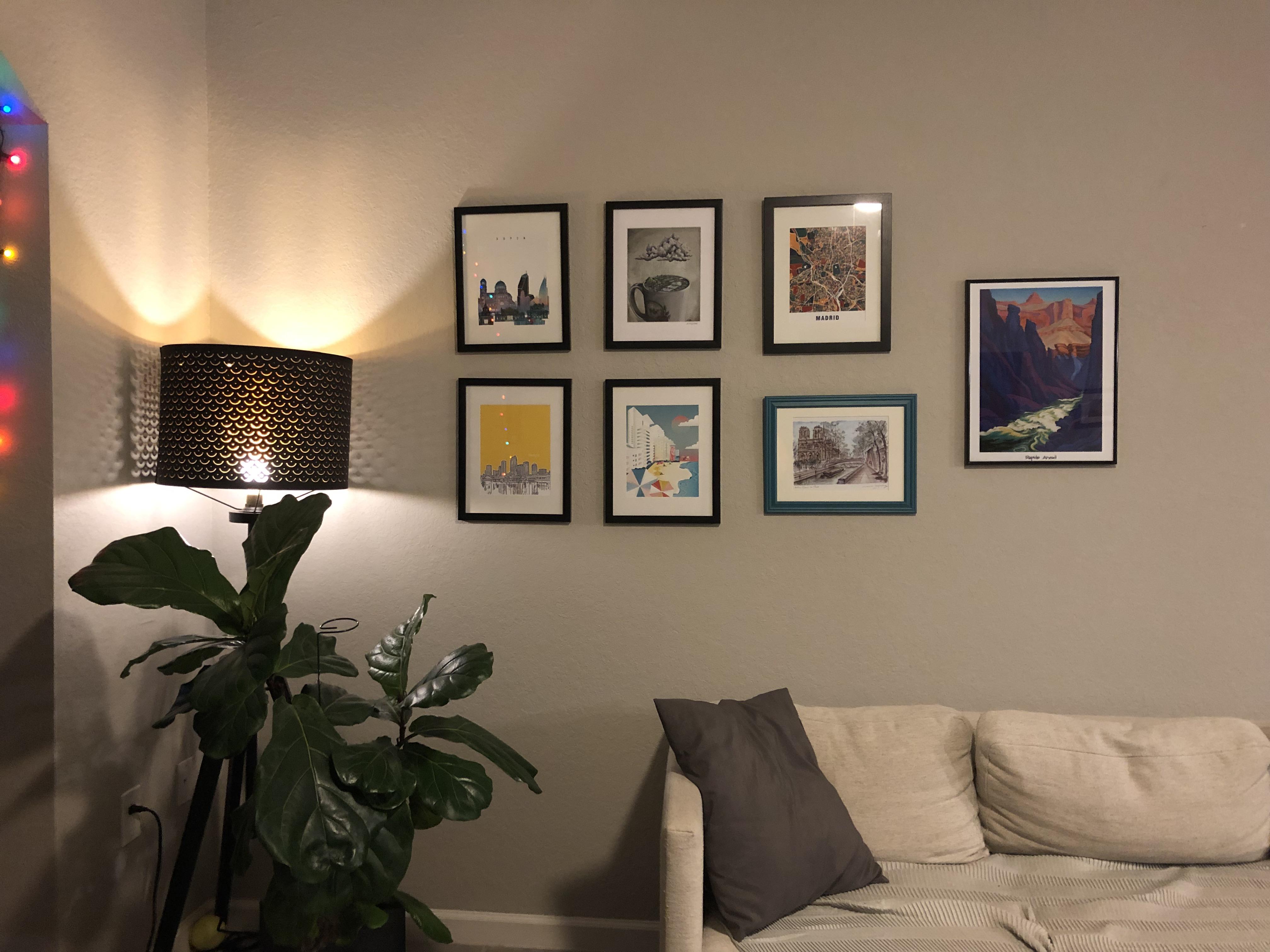 How to make this grid gallery wall over the sofa look better