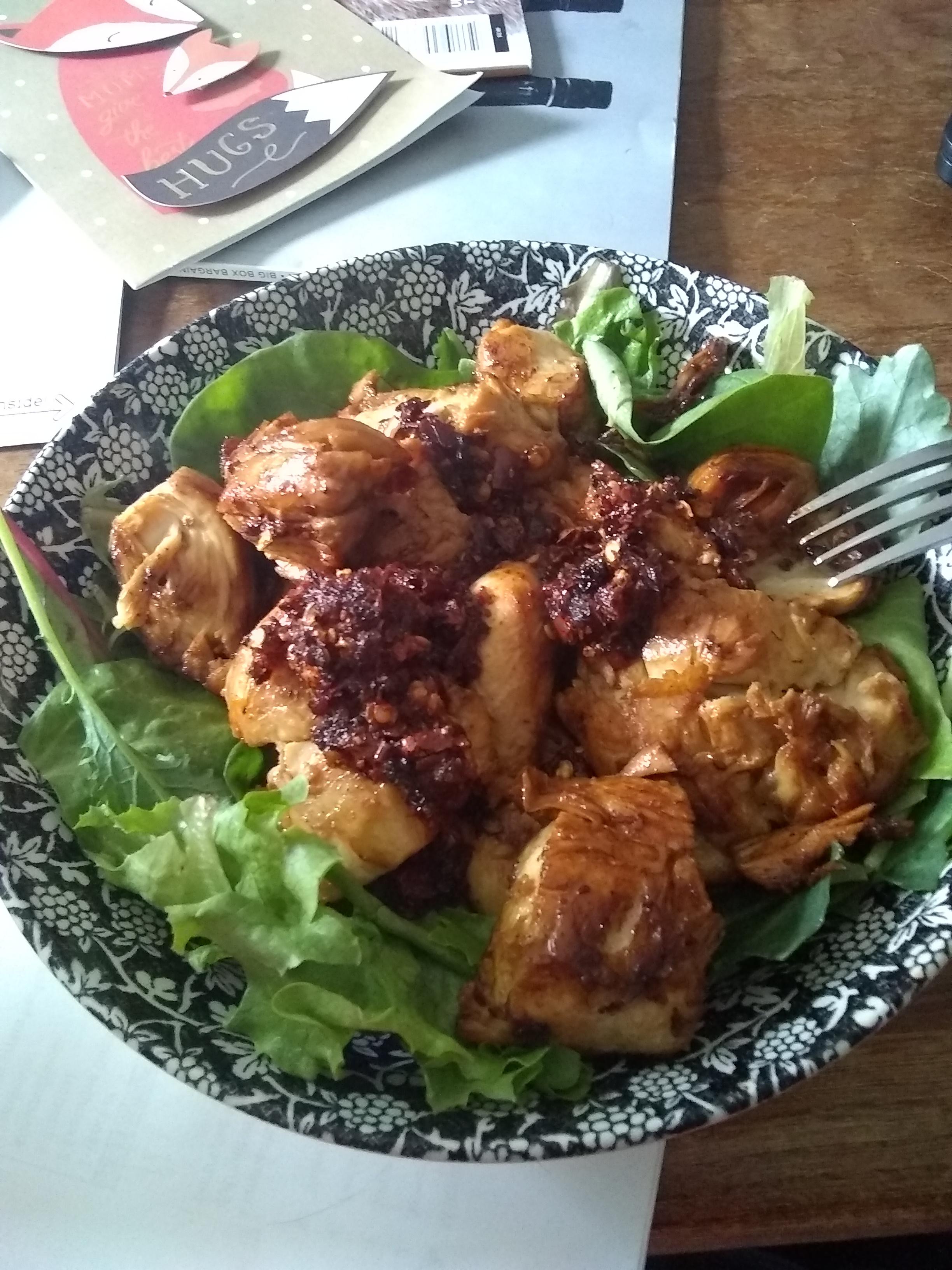 Chicken marinated in soy sauce and garlic over some greens with some