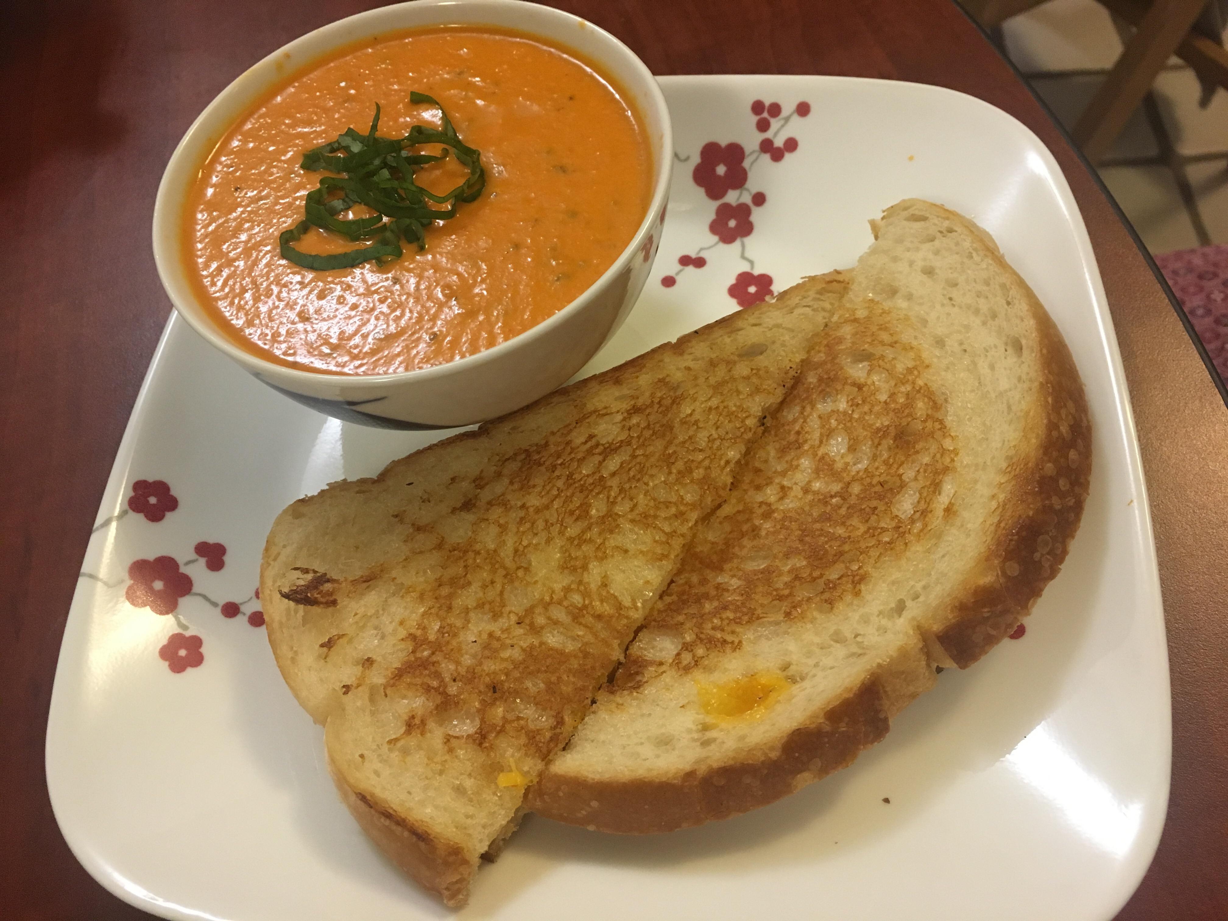 [Homemade] A grilled cheese made using duck fat and a bowl of tomato