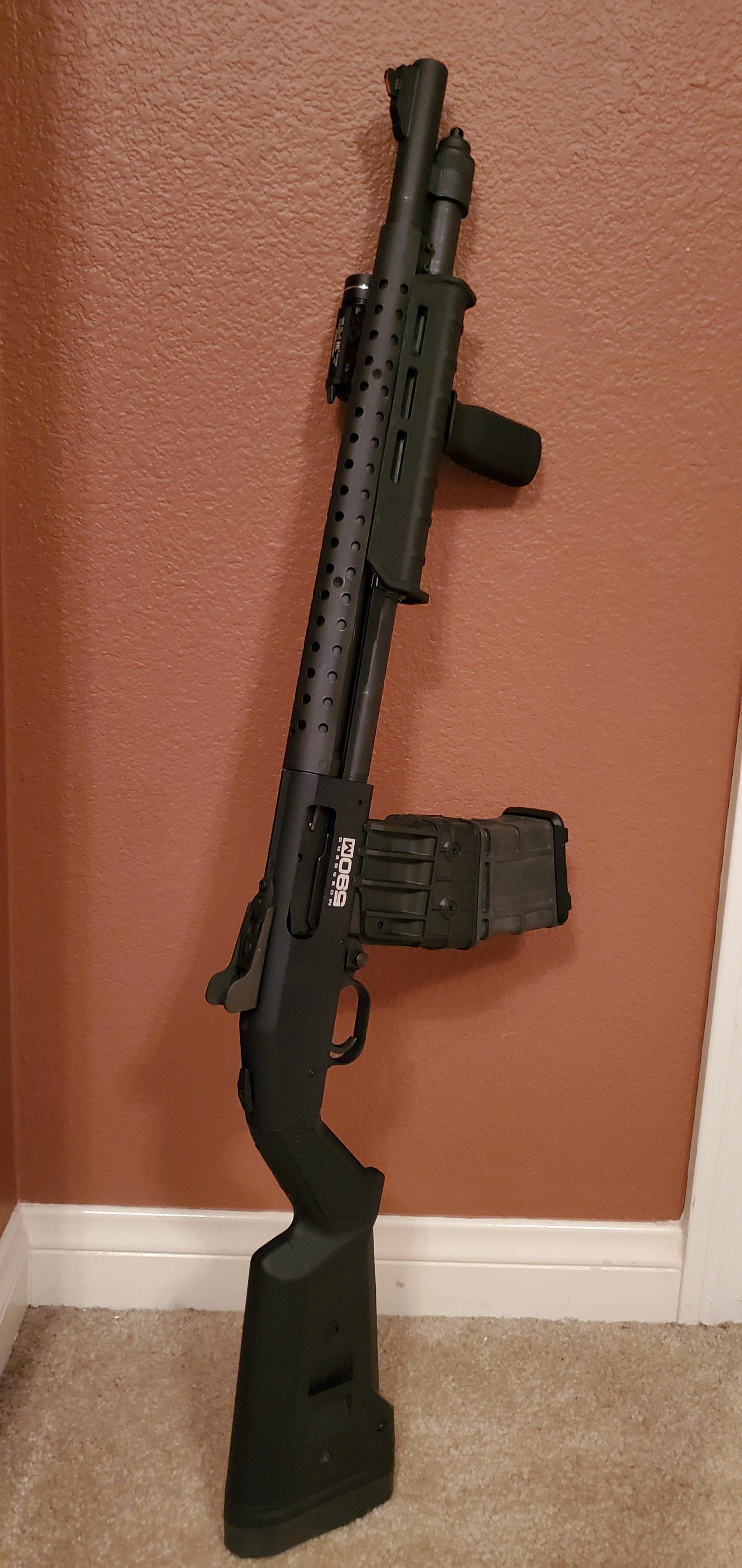 Mossberg 590M. Retained the heatshield with Magpul MOE Forend, Mail