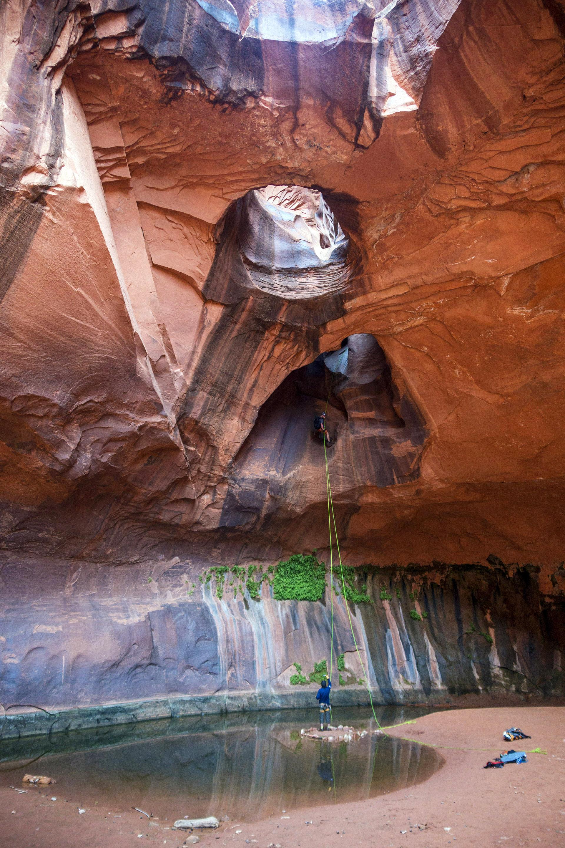 Rappelling down Golden Cathedral in Neon Canyon, Escalante, Utah, USA