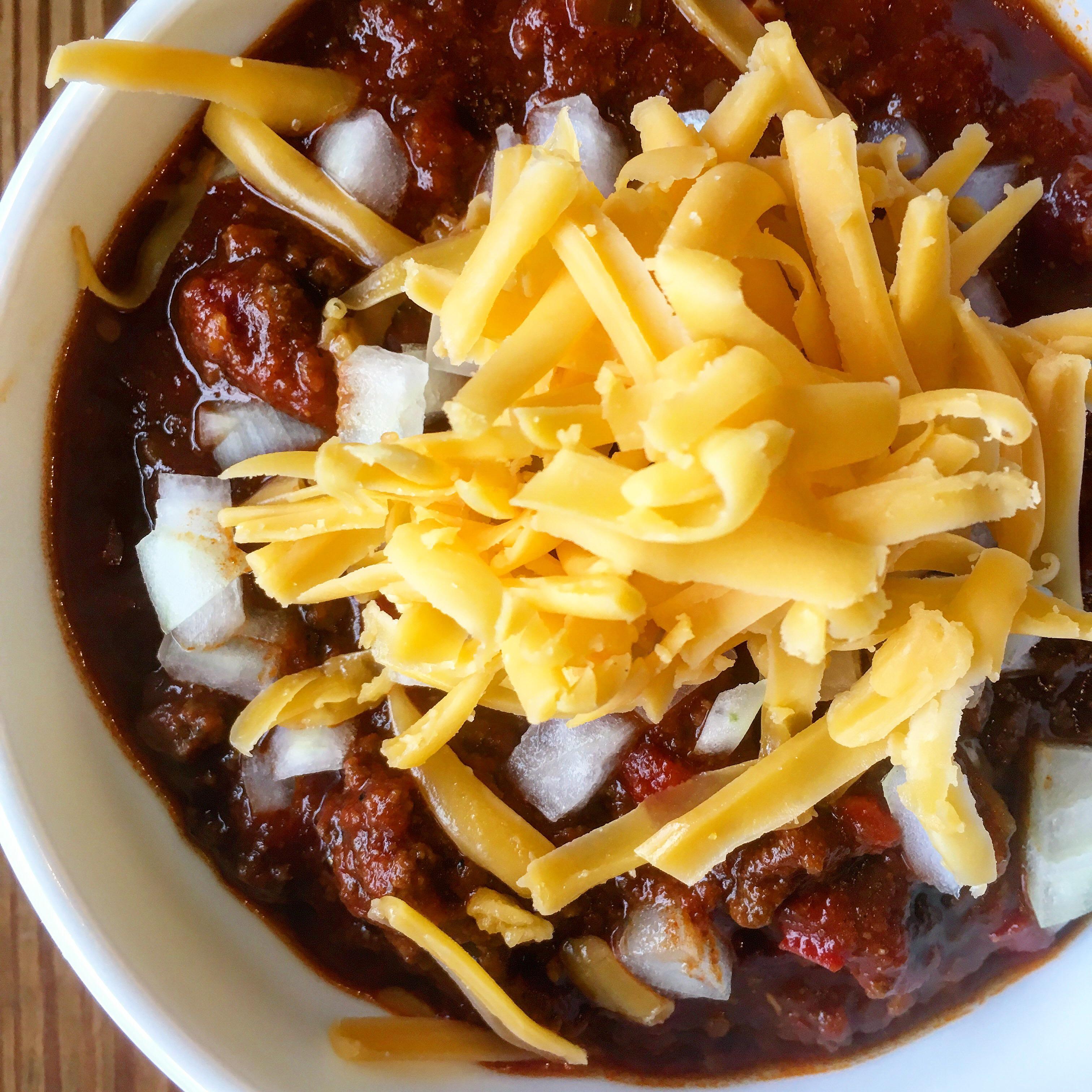 Beef chili with onion and cheddar. r/FoodPorn