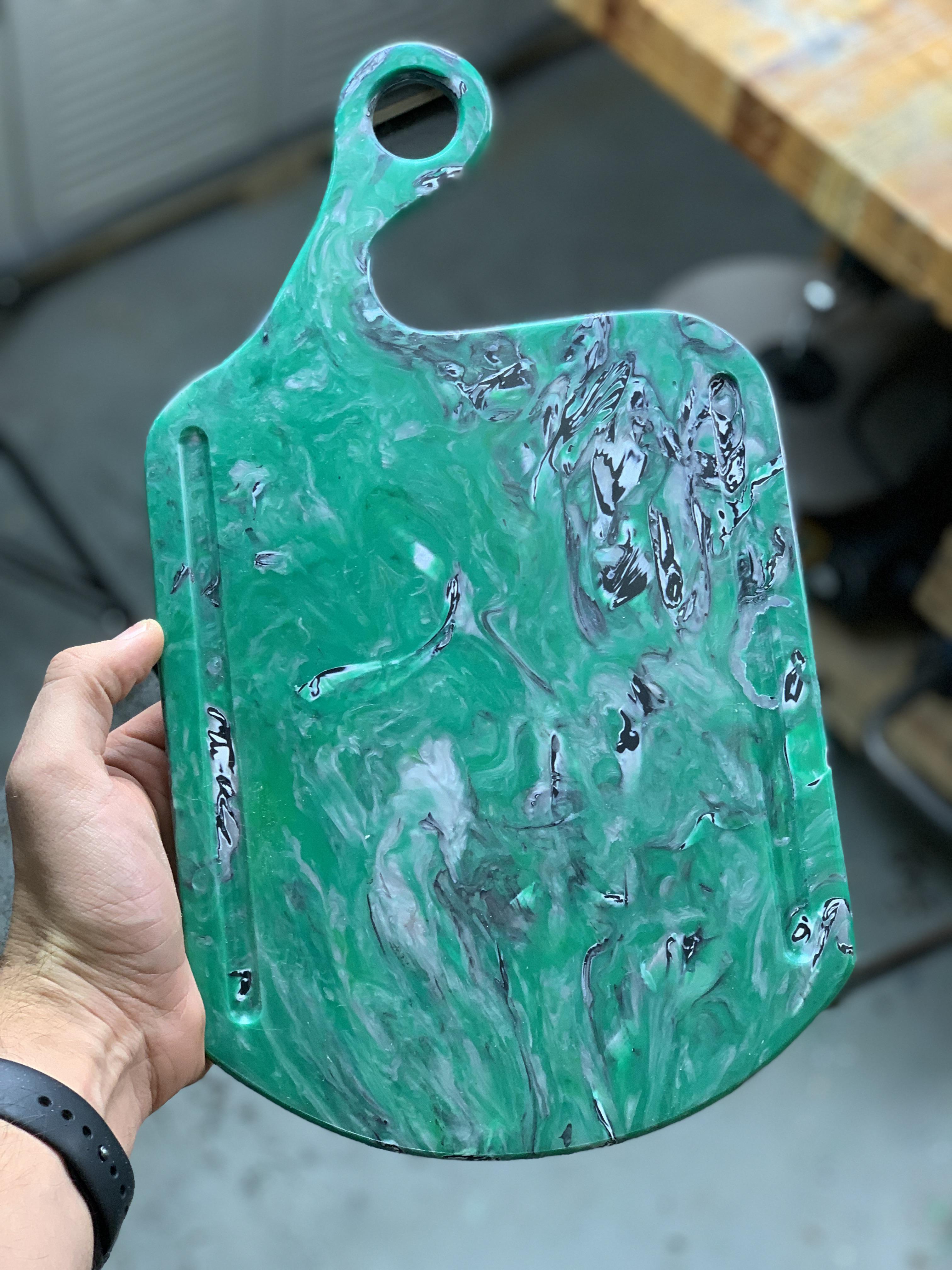 A charcuterie board made from plastic bottle caps collected, cleaned