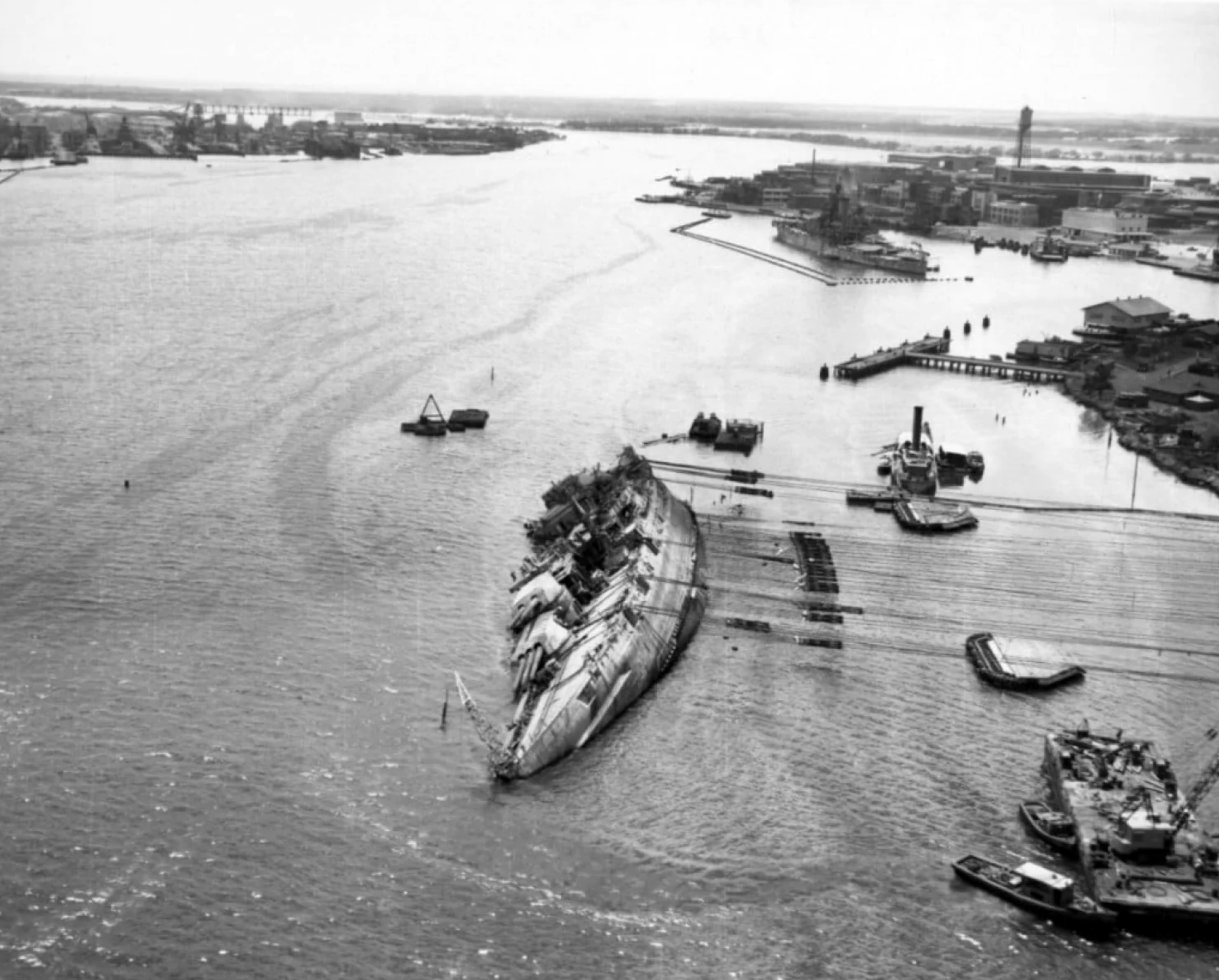 The USS Oklahoma sits in water in Pearl Harbor, Hawaii, on March 29, 1943, while under salvage