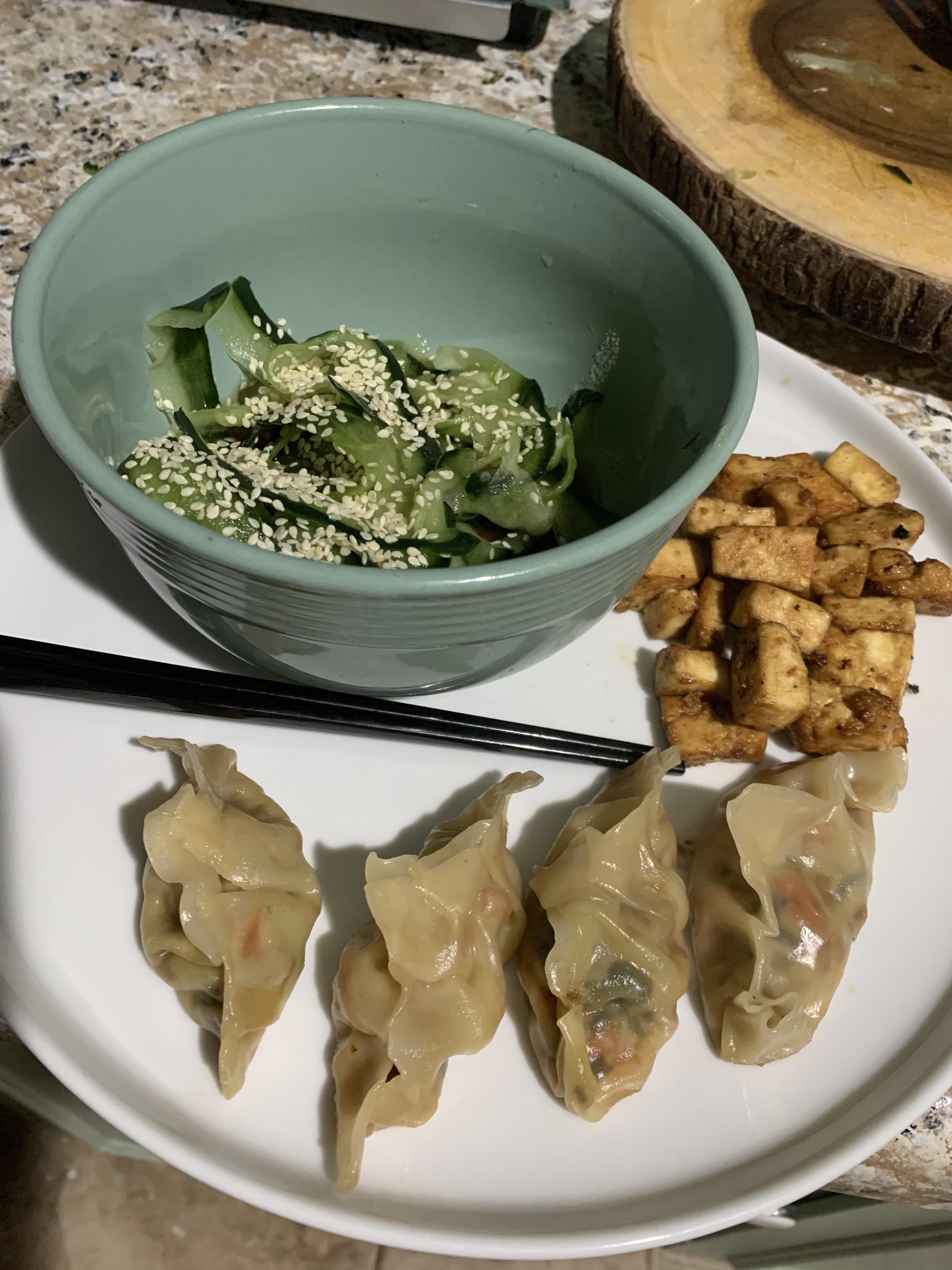 Home made veggie gyoza, air fried tofu and cucumber salad. r