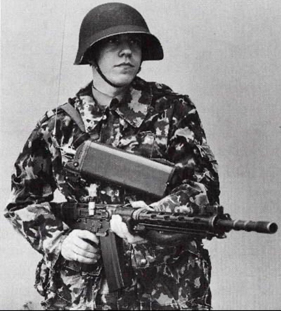 A swiss soldier poses for a photo with a stg57 1960s or 70s [1080x1194