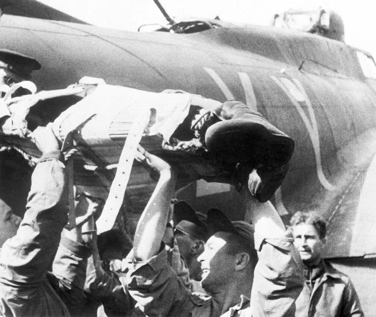 A wounded member of the crew of a US Flying Fortress, safely returned