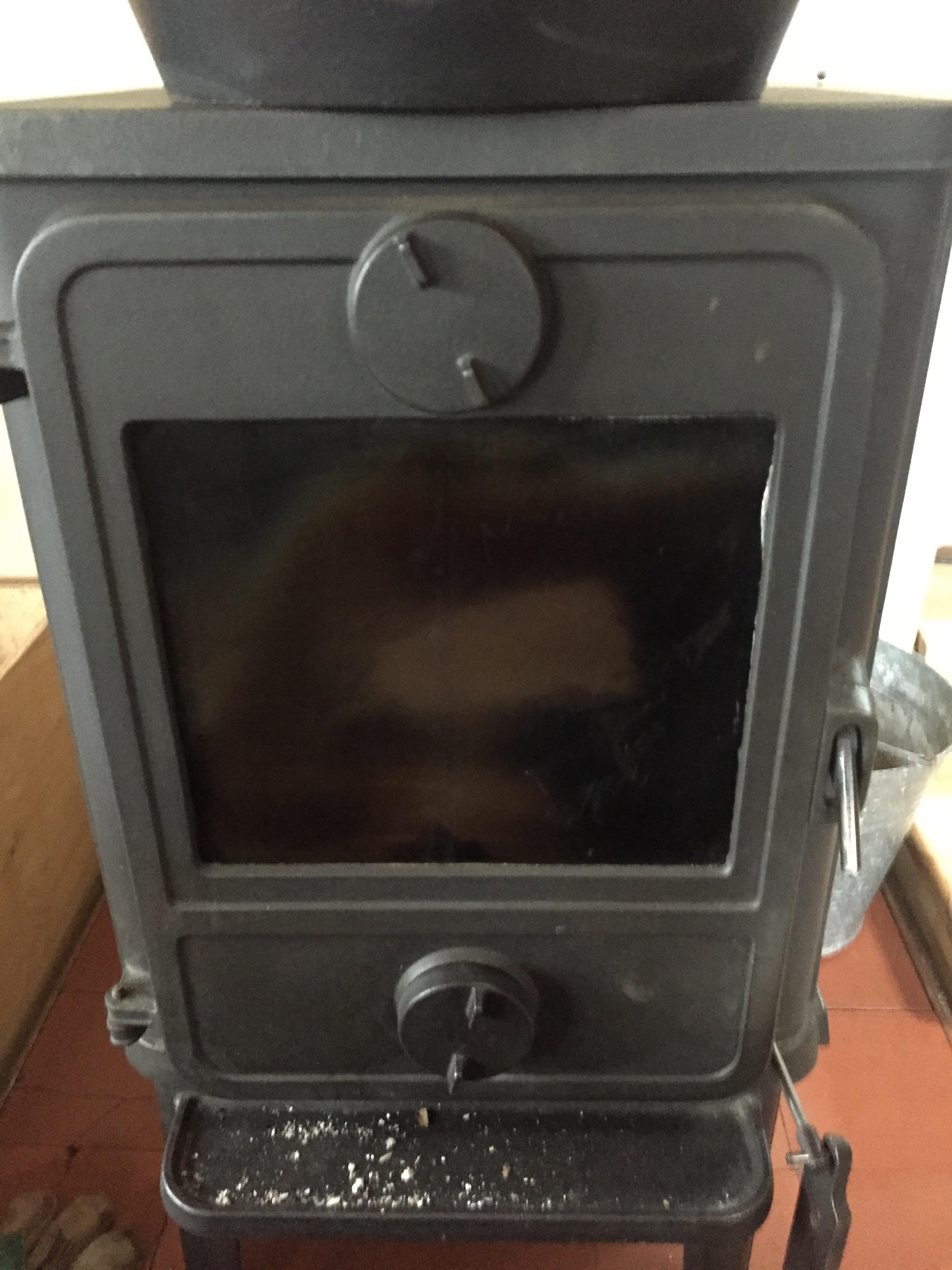 My parents have a soot stain on the glass panel of their wood stove