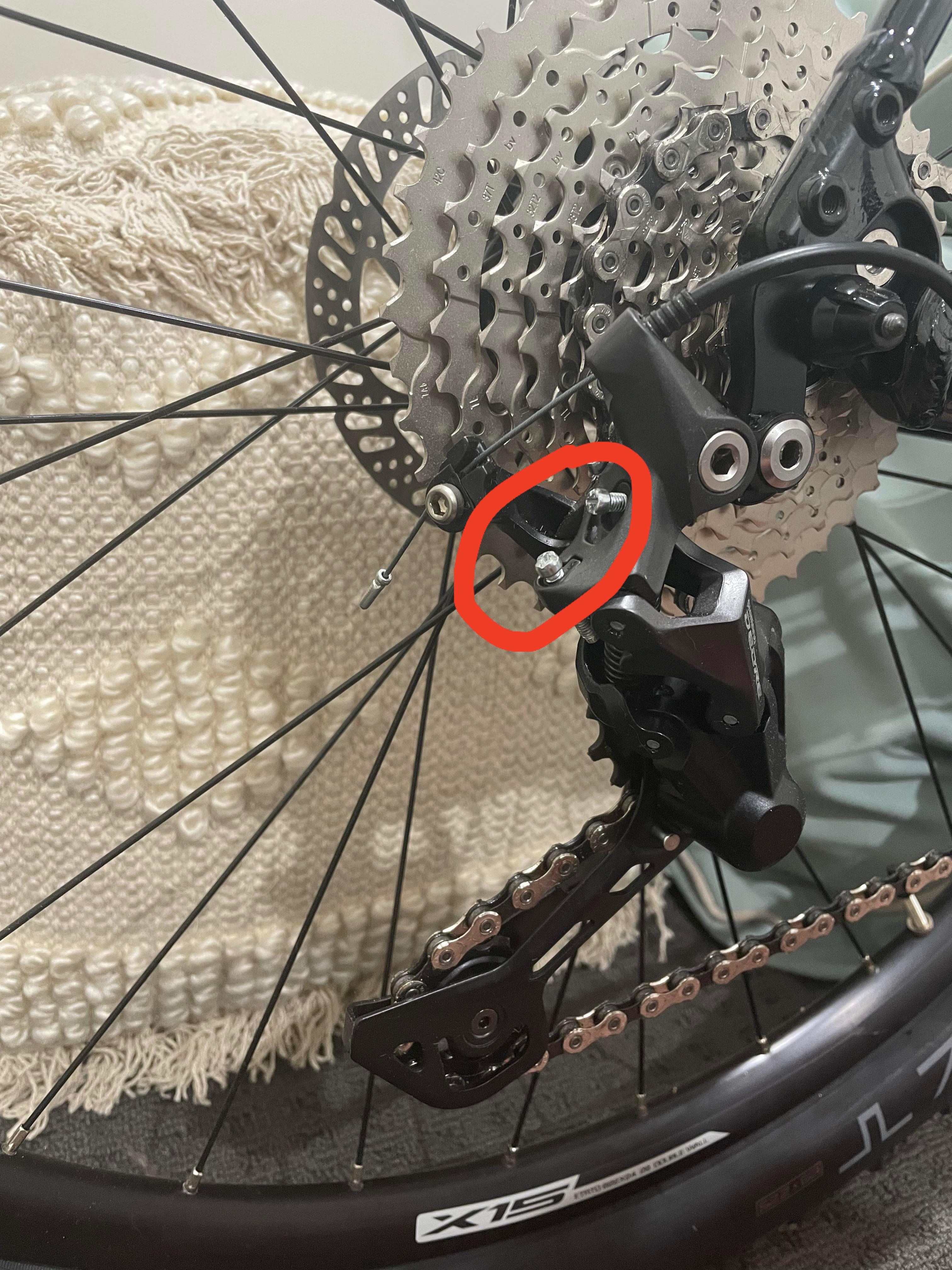 What are these screws on my rear derailleur and should they be screwed