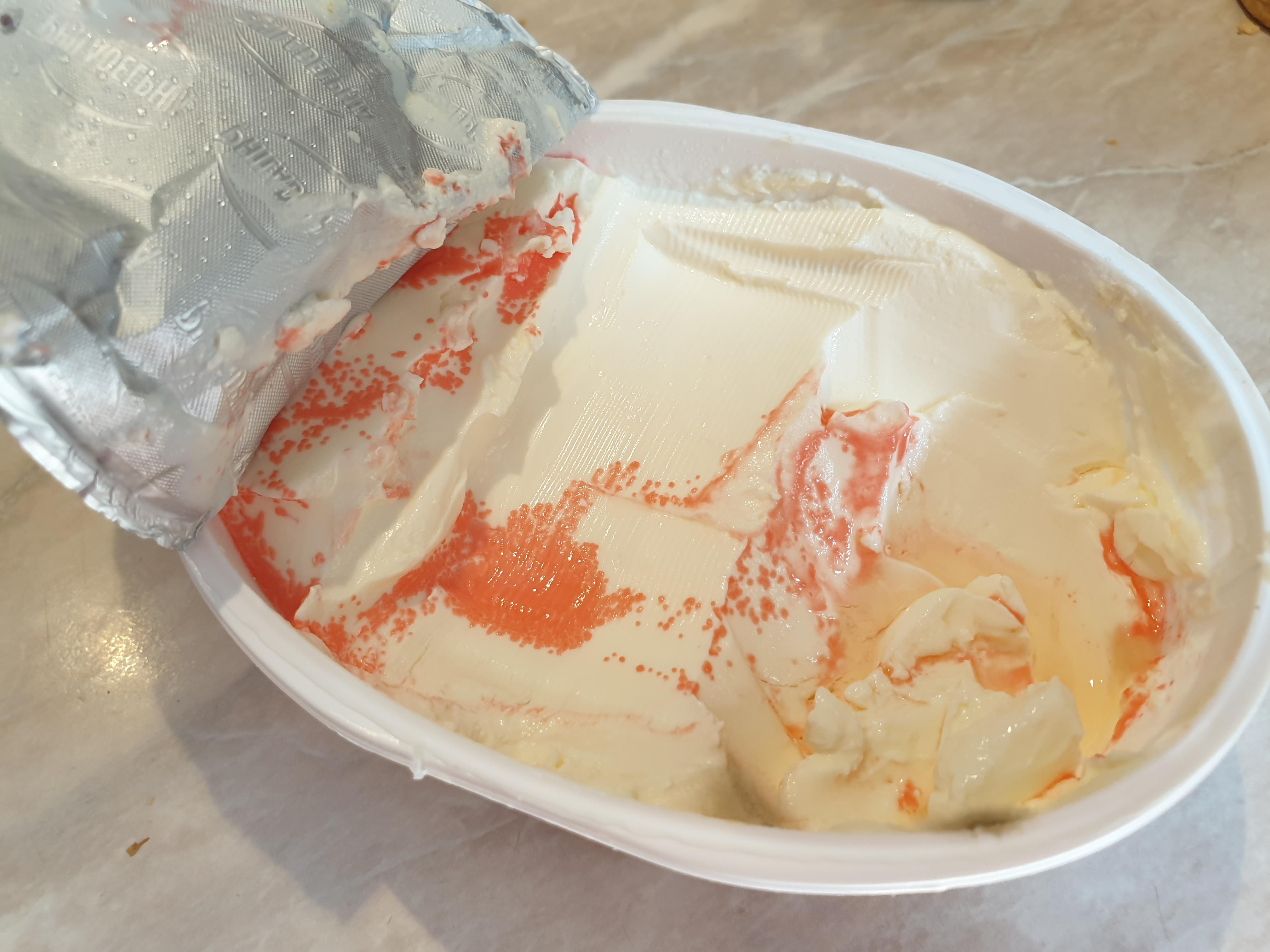 What is this pink microbe on my Philadelphia cheese? Just curious and