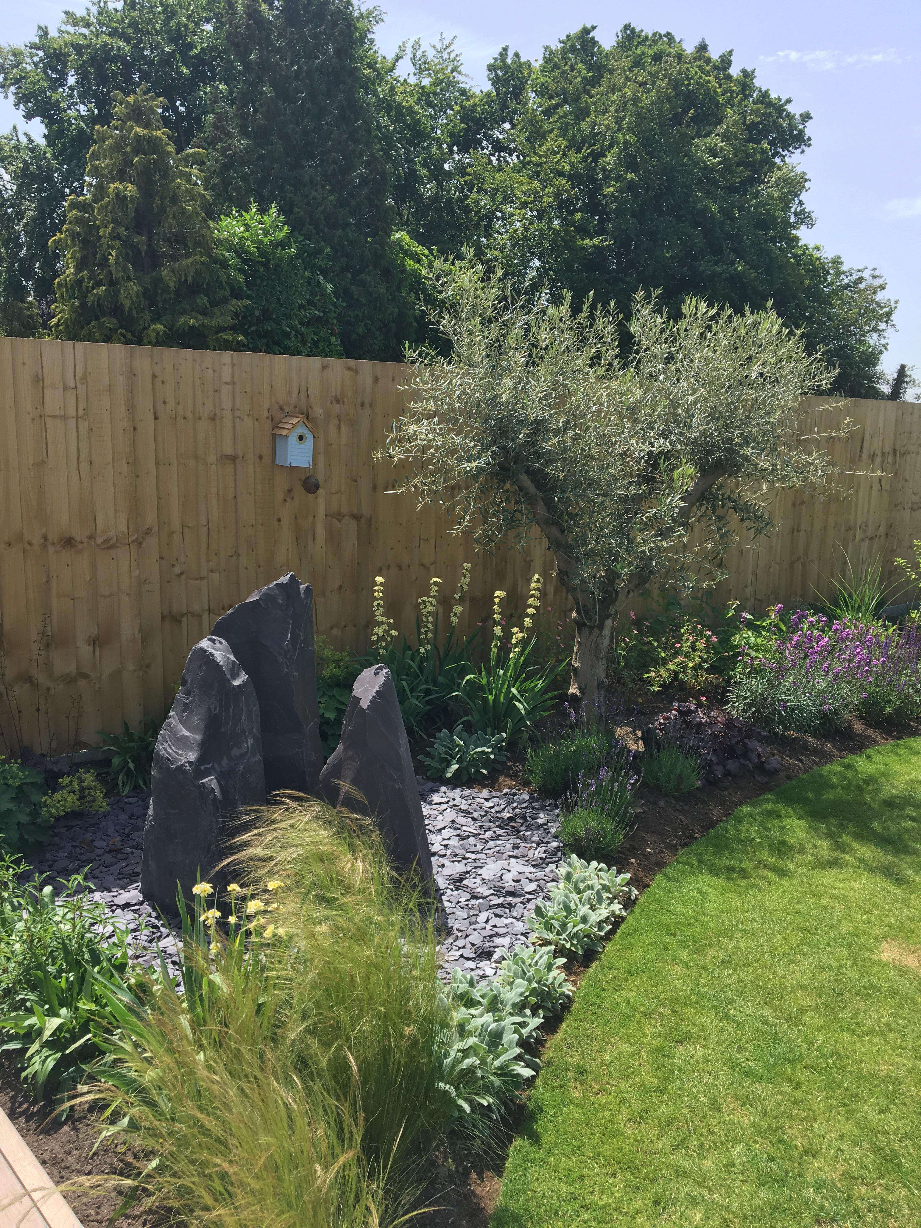 Project completed. Water feature and olive tree. r/landscaping