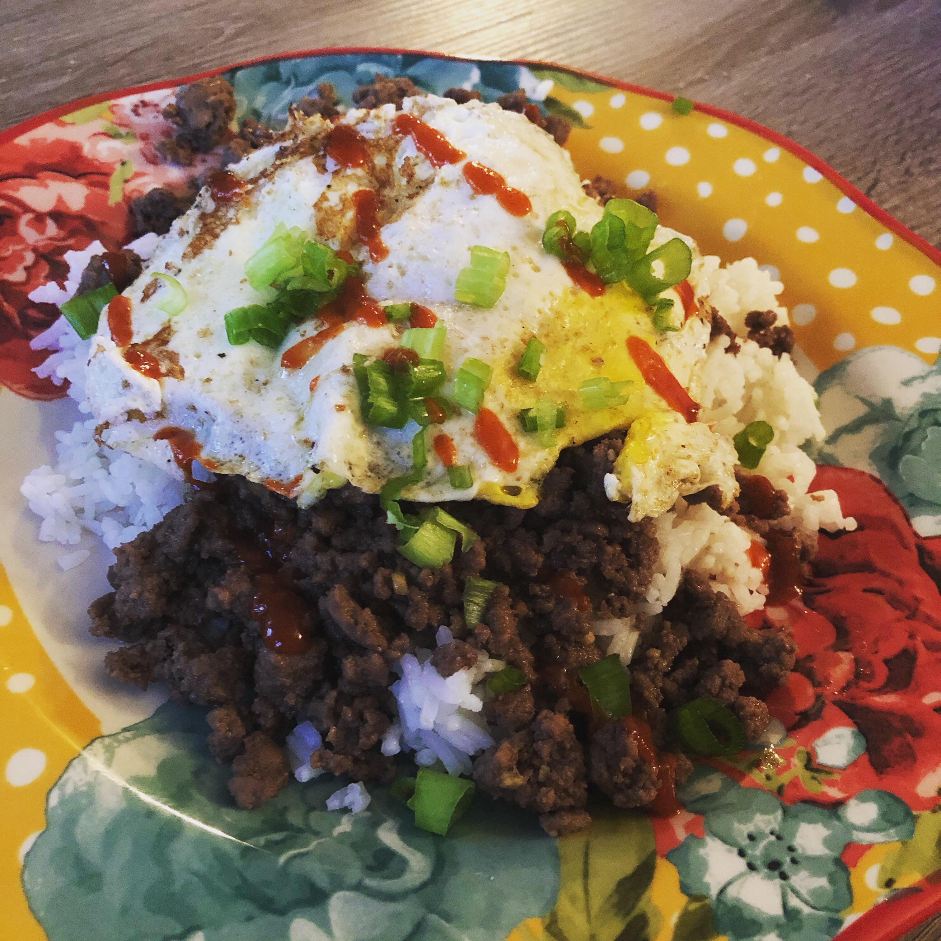 Korean ground beef over white rice with a fried egg, green onion and