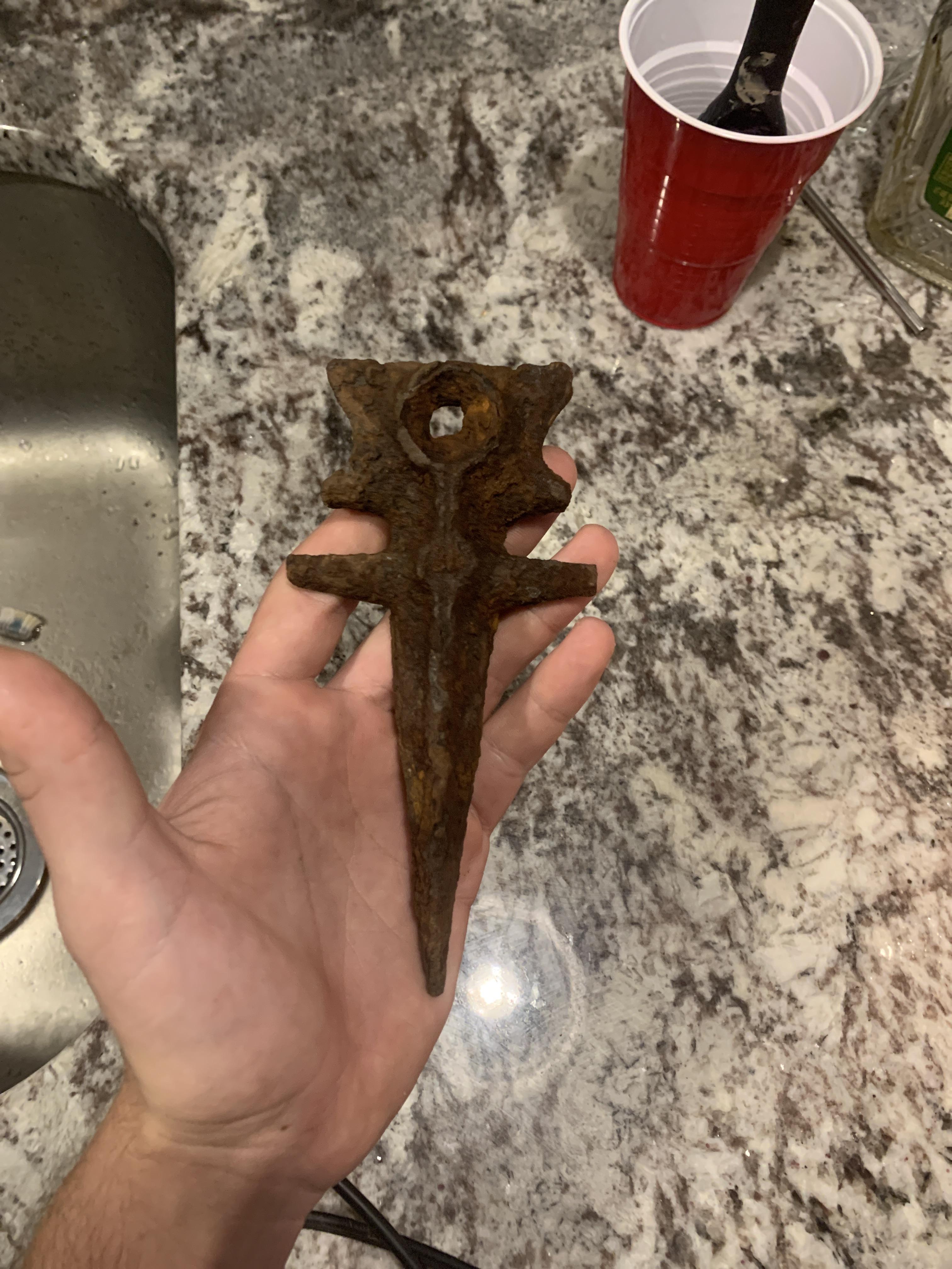 Found this today about 10 inches under. Any clue what it is looks like some sort of stake to me
