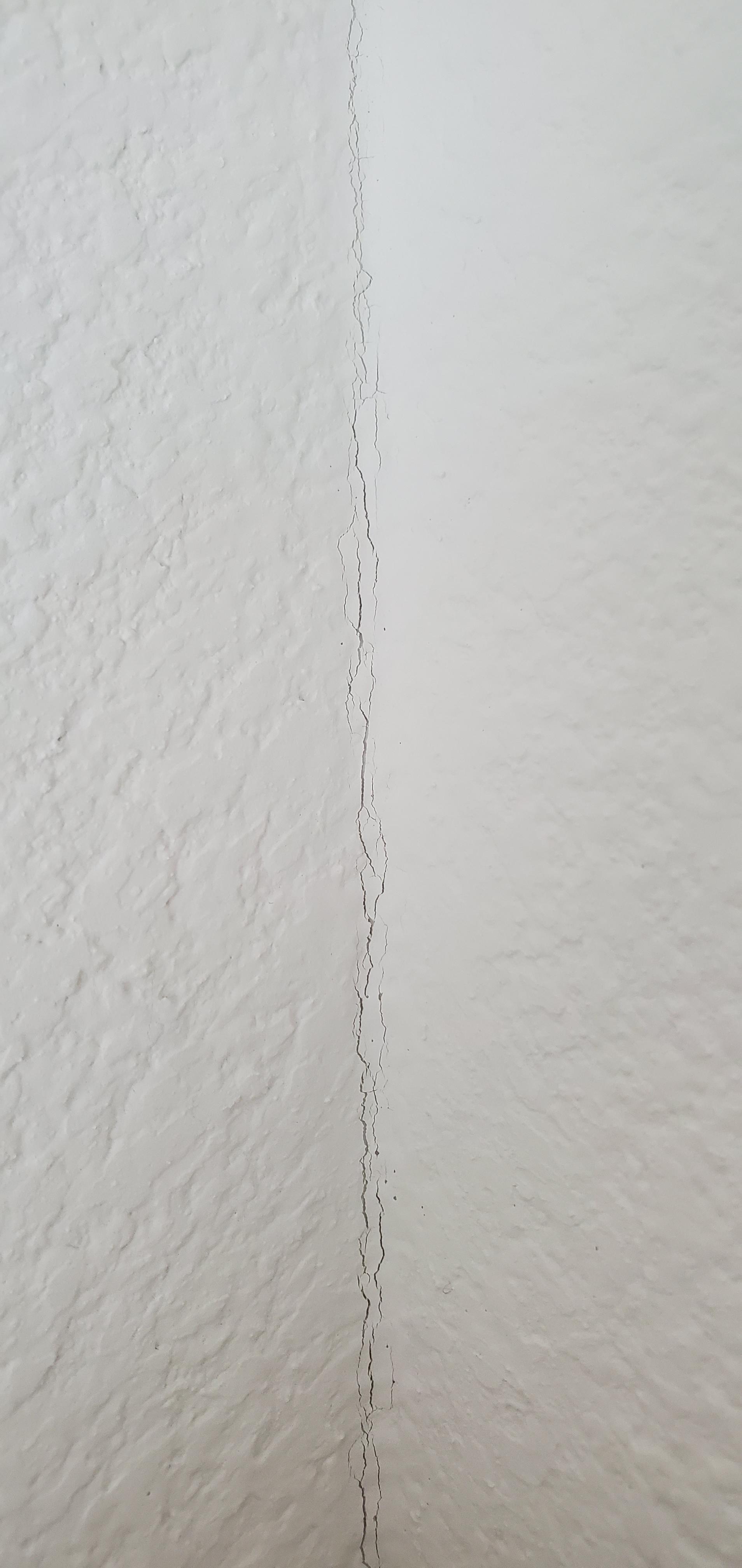 How do I repair these small cracks found in the corners of the walls