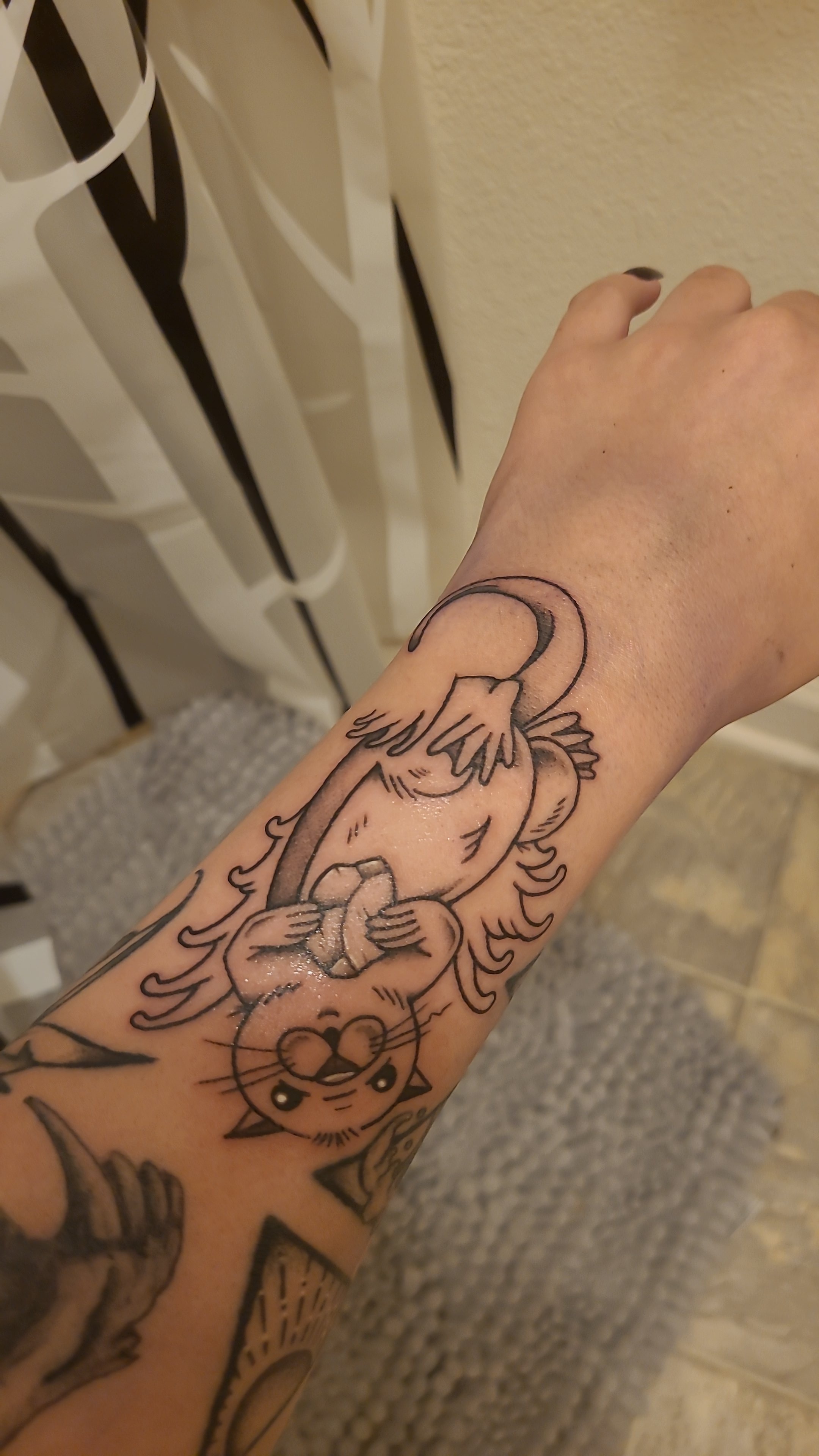 Otter holding a pebble done by Andrew at Flagstaff Tattoo Company