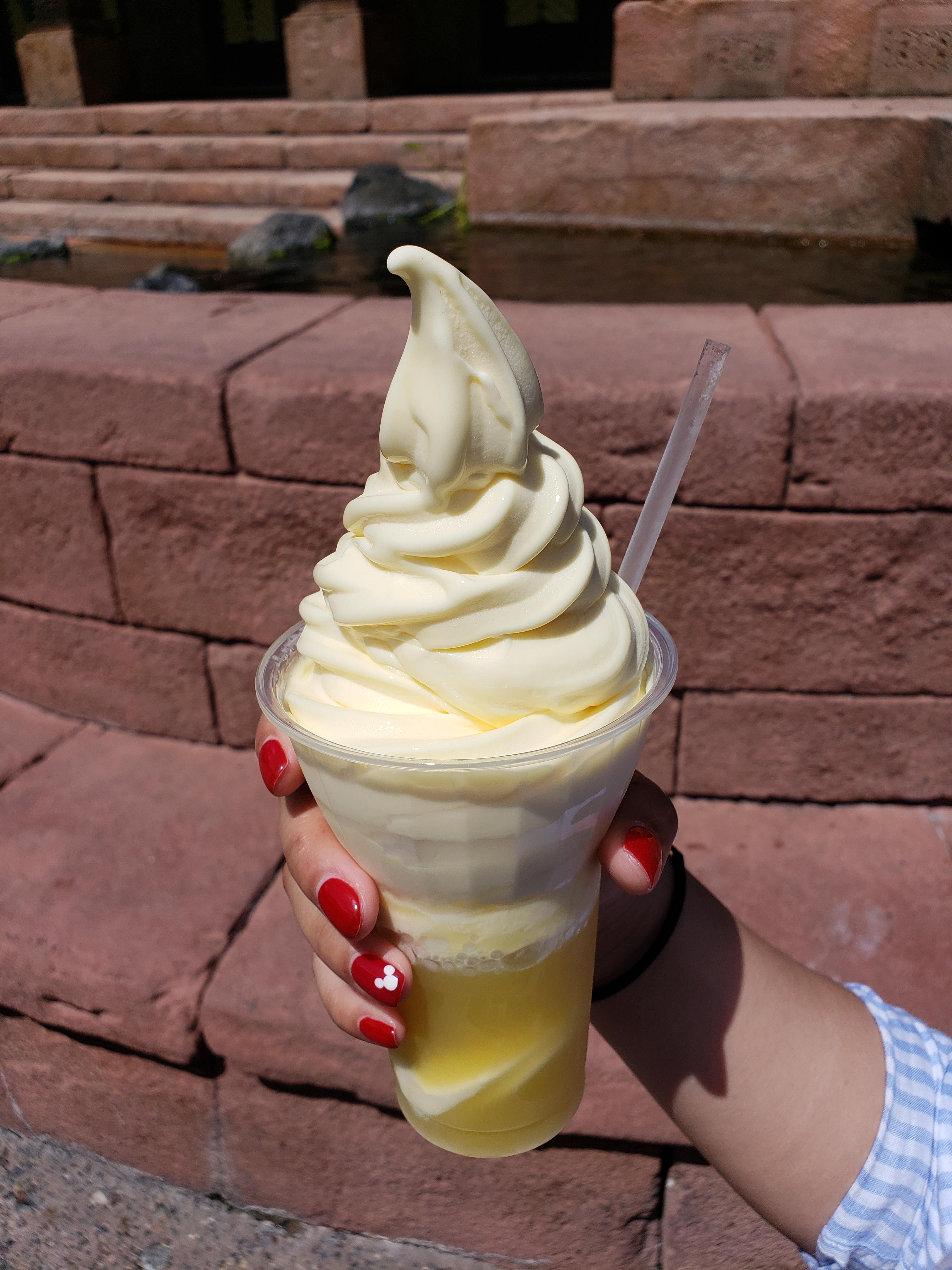 Picture of my favorite treat in WDW. My gf holding a Pineapple Dole