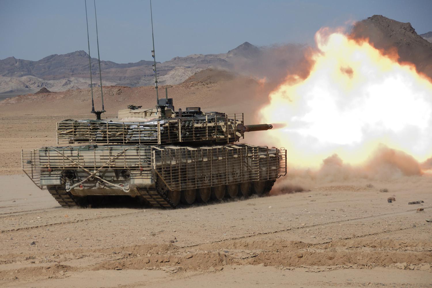 A Leopard 2A6M CAN tank of the Canadian Army opens fire at suspected