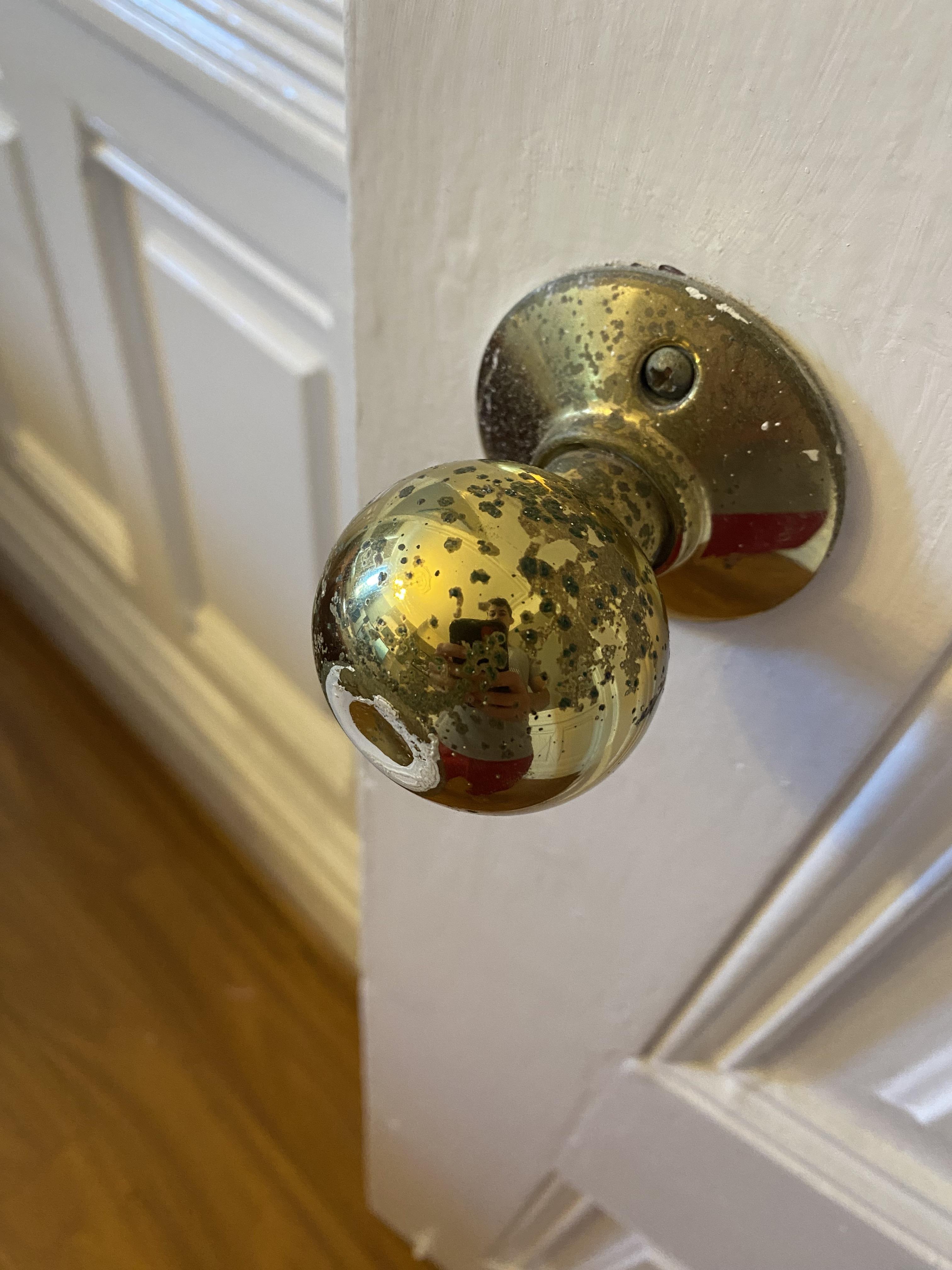 Green spots on my door knob. I can scratch it off with my fingernail
