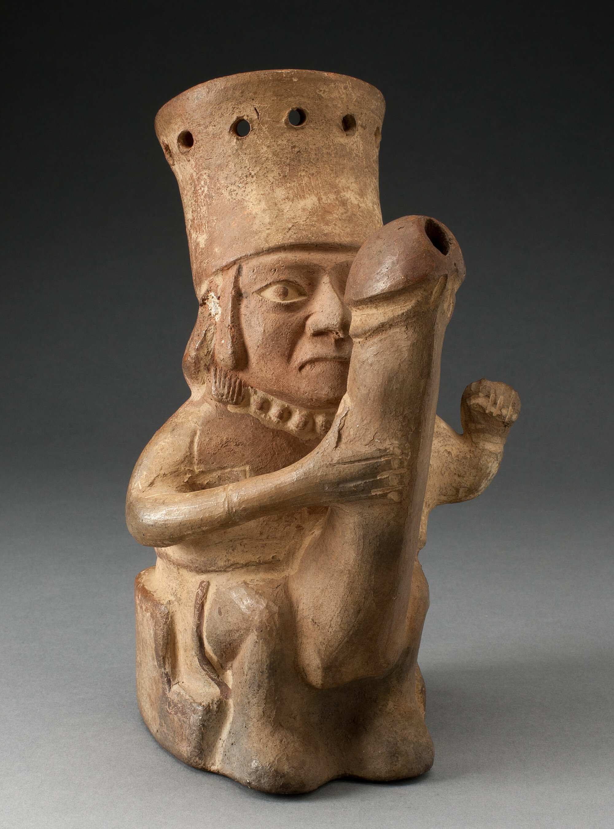 Rhyton shaped like a man with exaggerated phallus. Peru, Moche