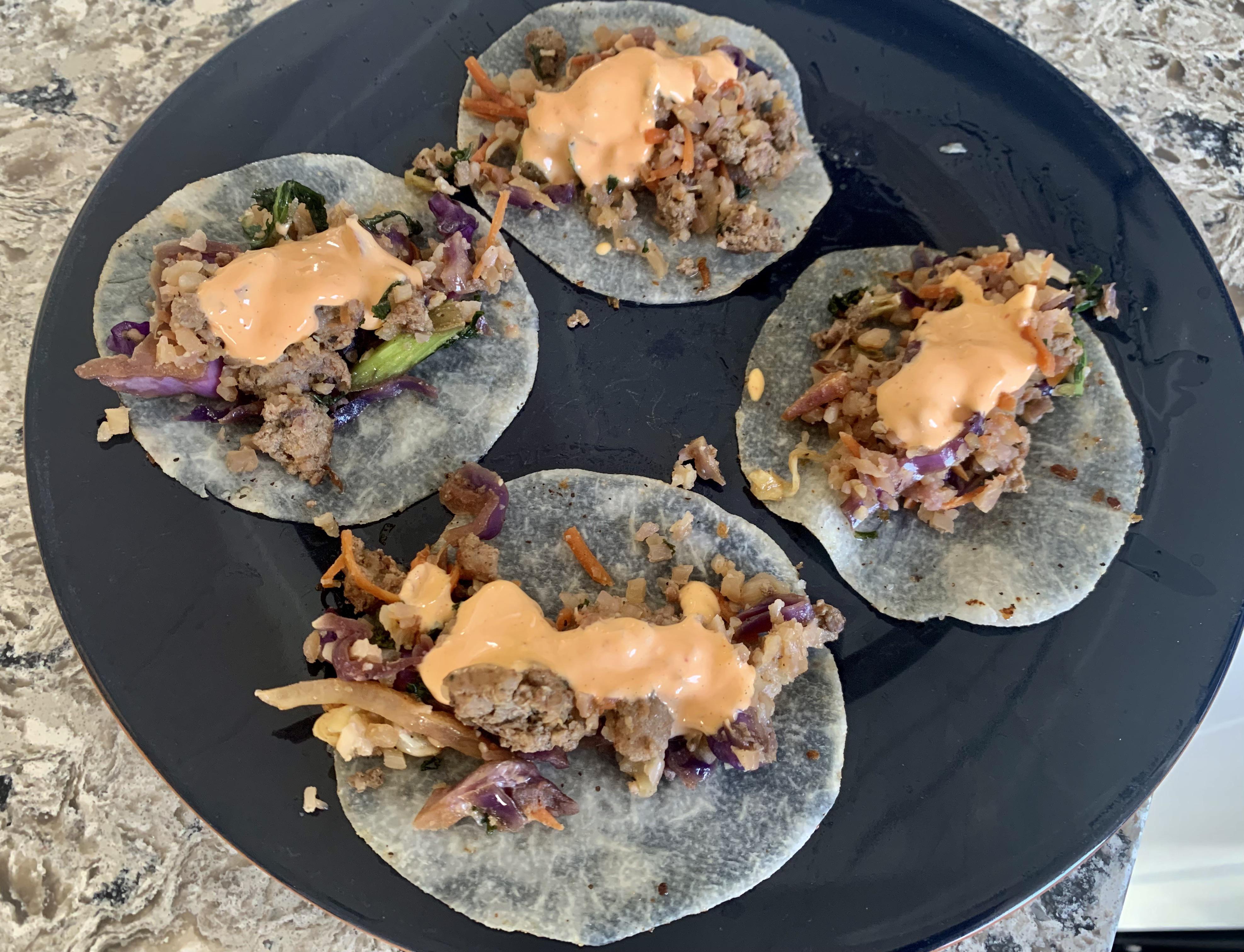 R1D26 leftover egg roll in a bowl with sesame aioli on jicama wraps