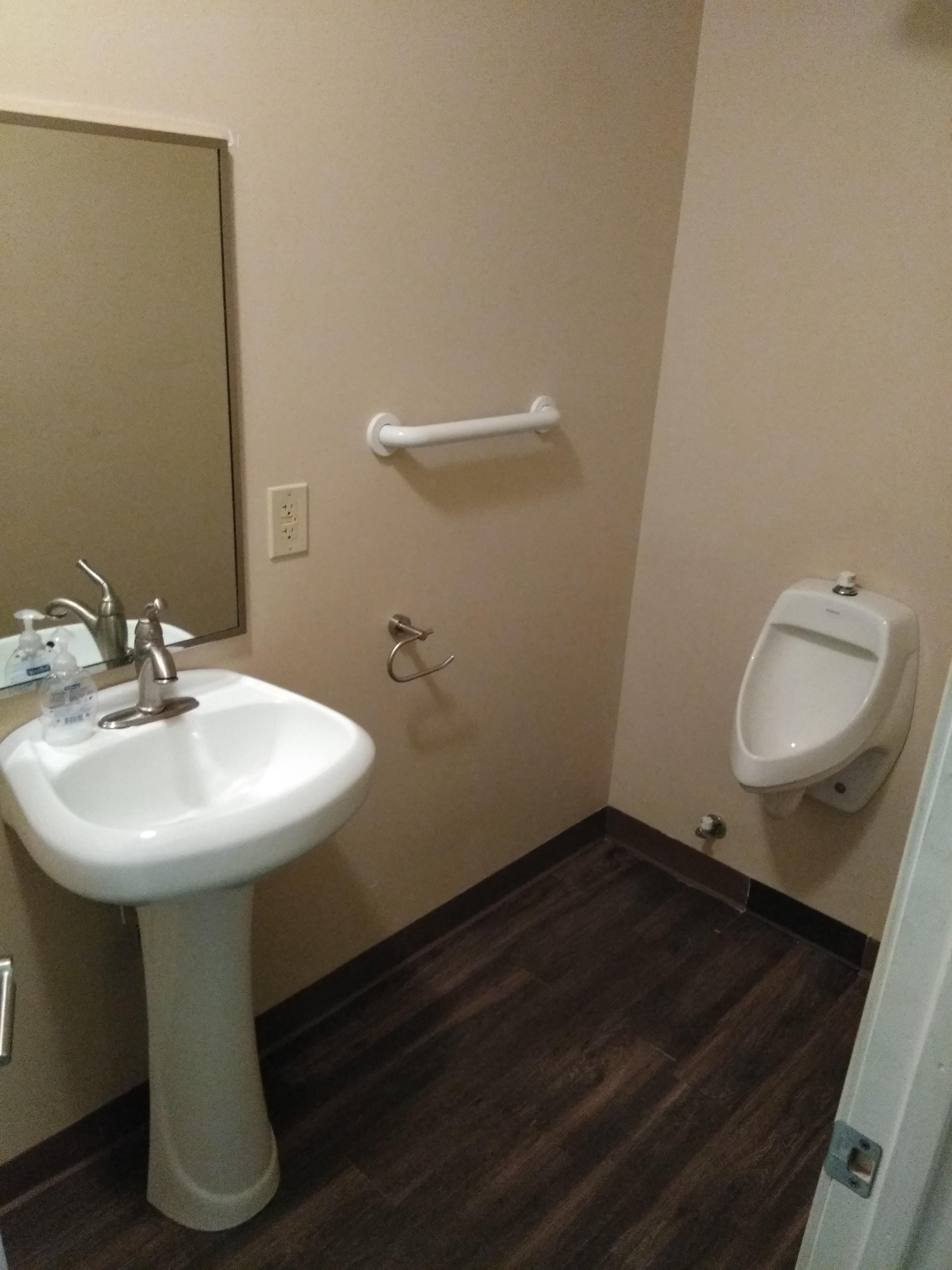 A restroom that is just a urinal. ofcoursethatsathing