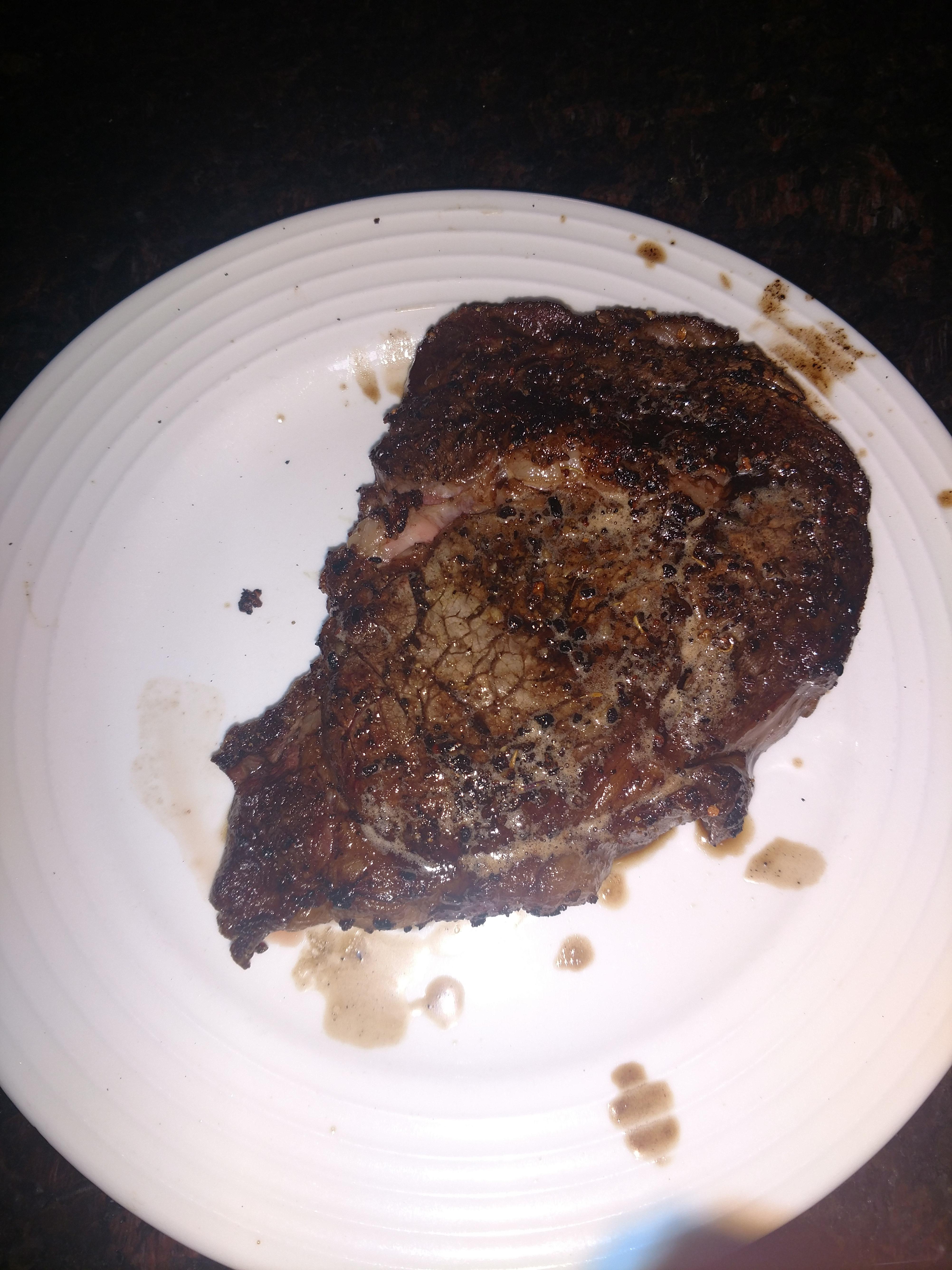 Delmonico steak cooked on cast iron skillet with some butter and thyme