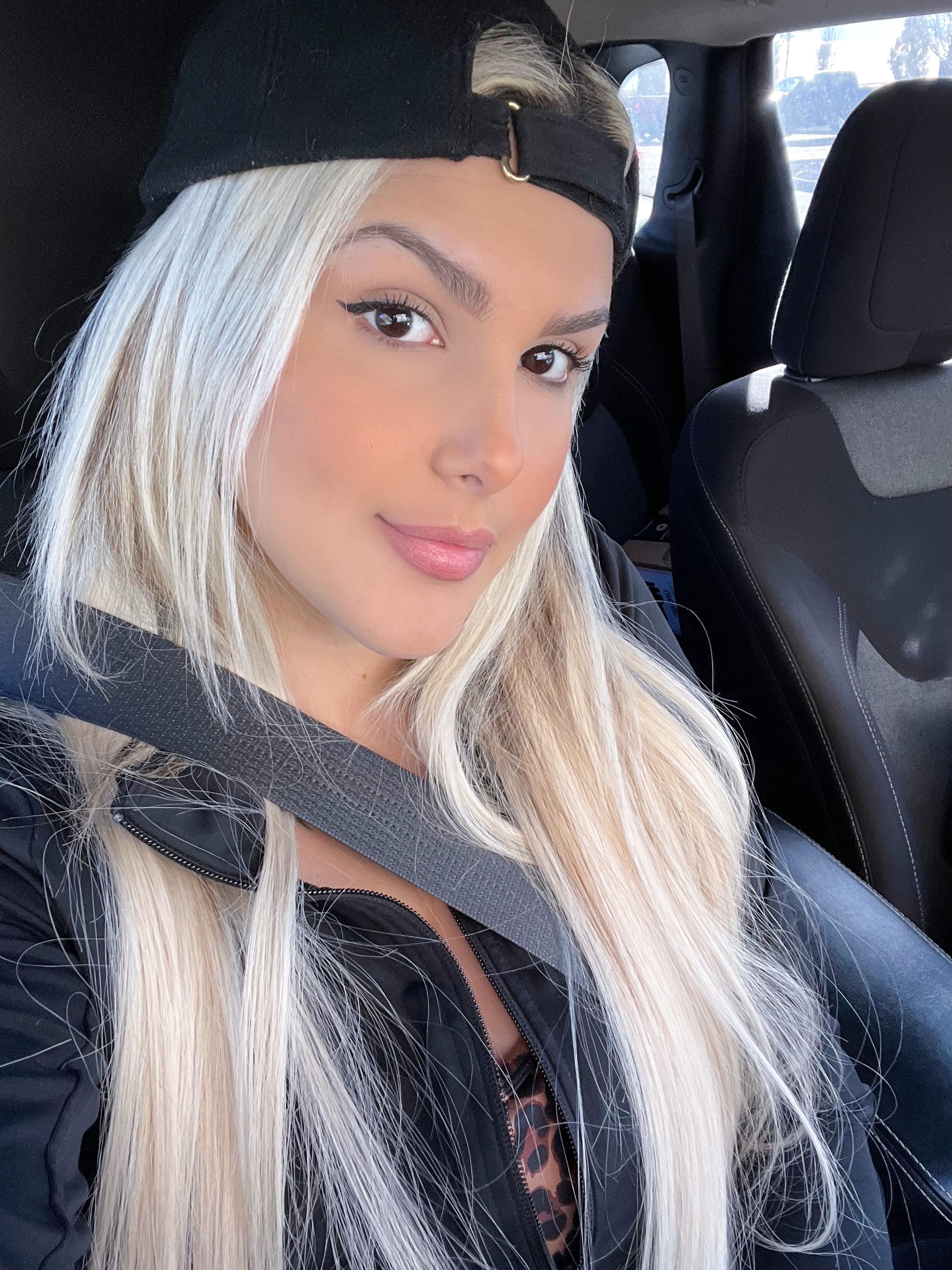 The face of a girl who’s not used to wearing a hat backwards but thinks