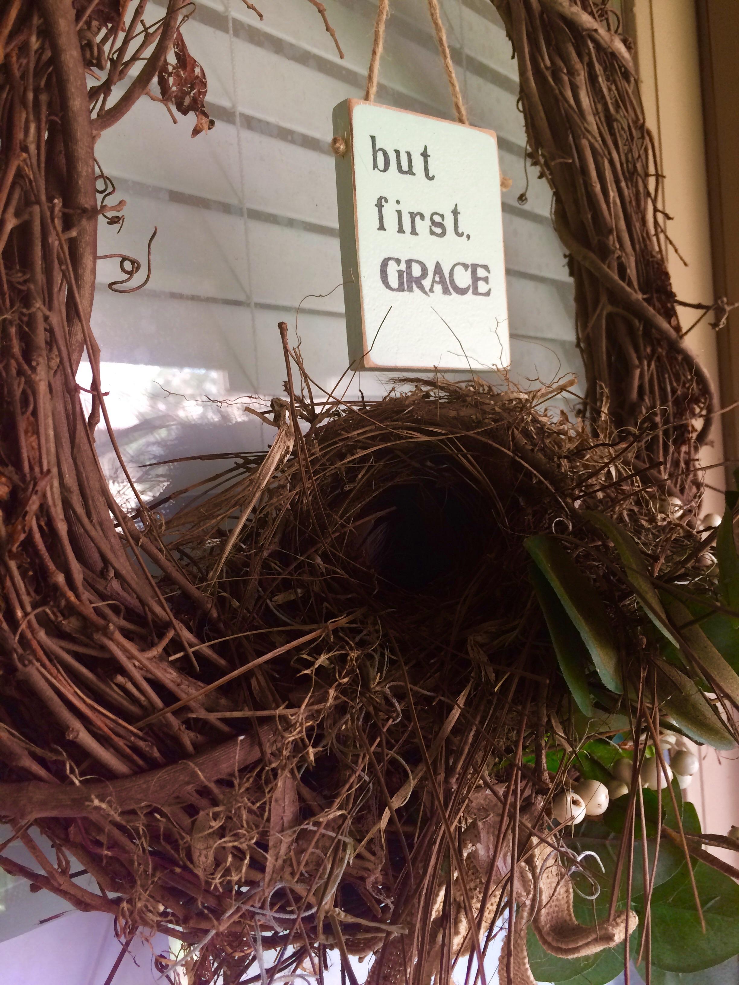 A sparrow has built her nest on my wreath that's hanging from my front