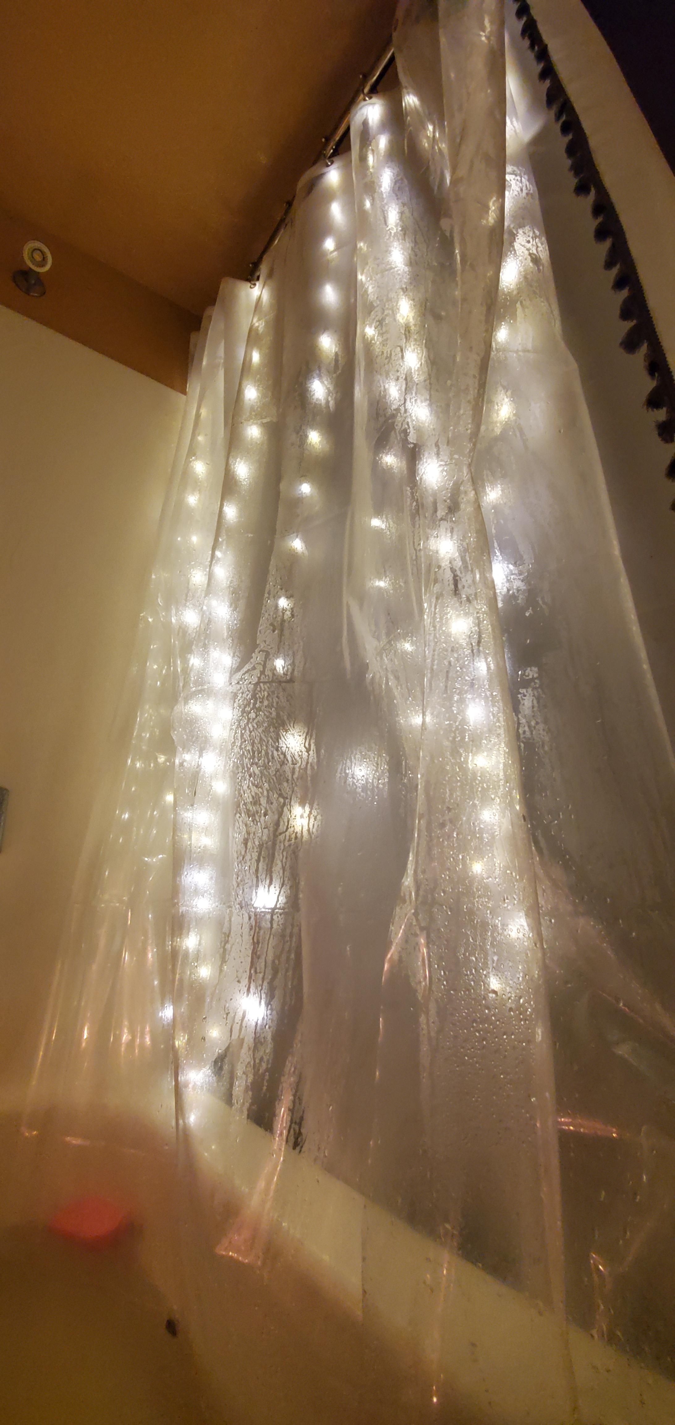 Hang fairy lights between your shower curtain and liner for more