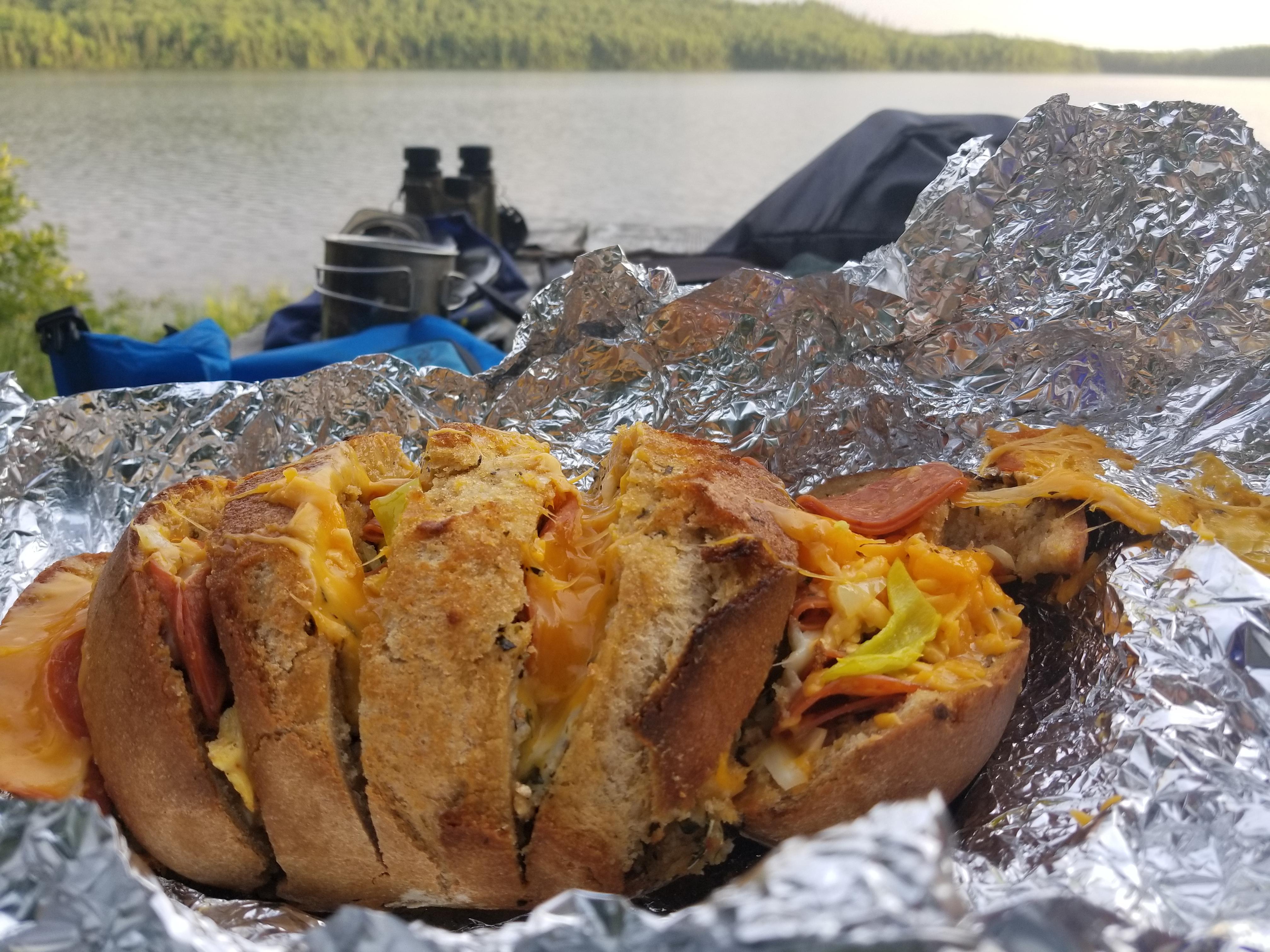 Gourmet camping meal, made a loaf of stuffed bread wrapped in tinfoil