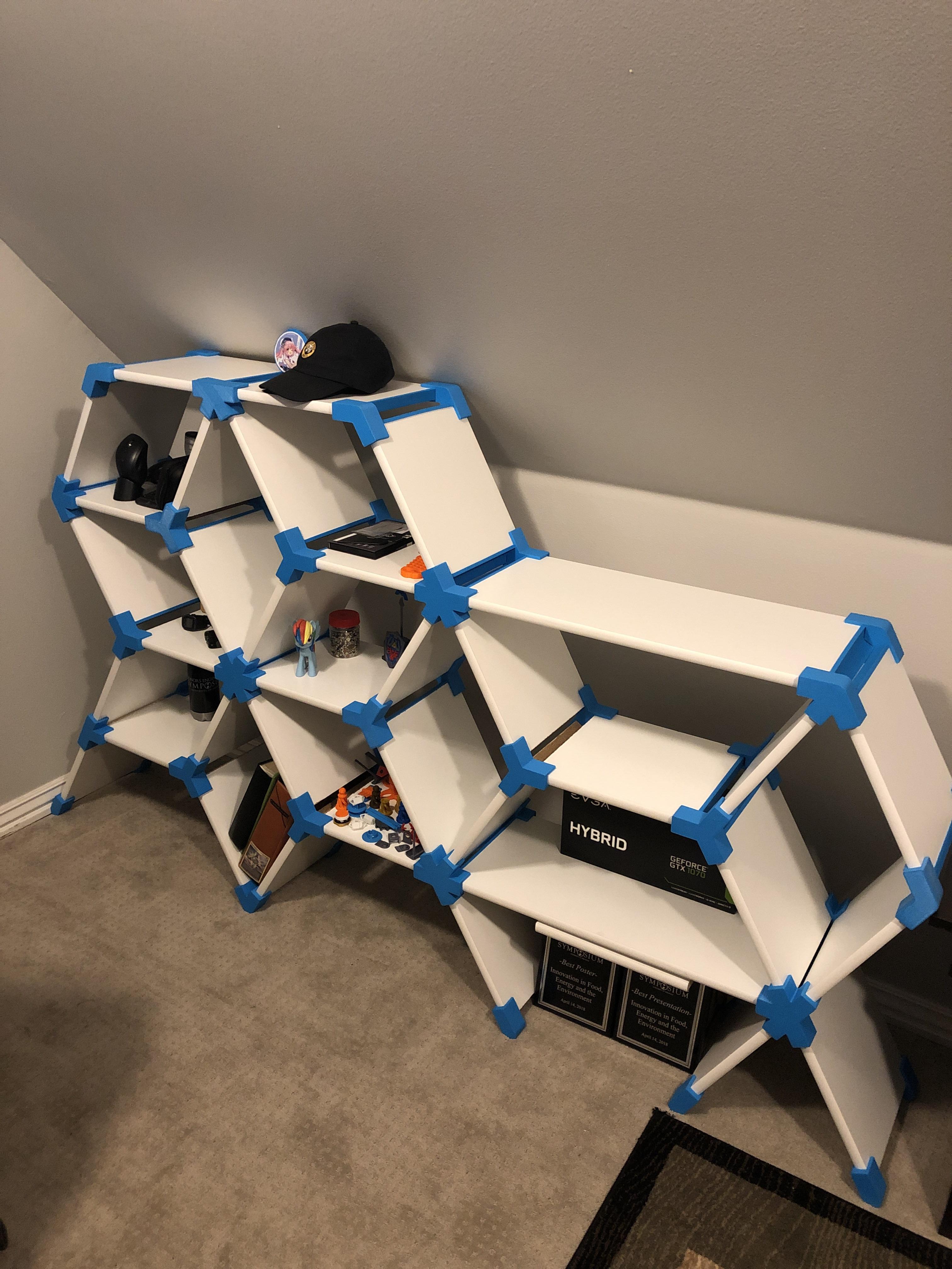 All of the brackets are 3D printed in this modular shelf my friend made