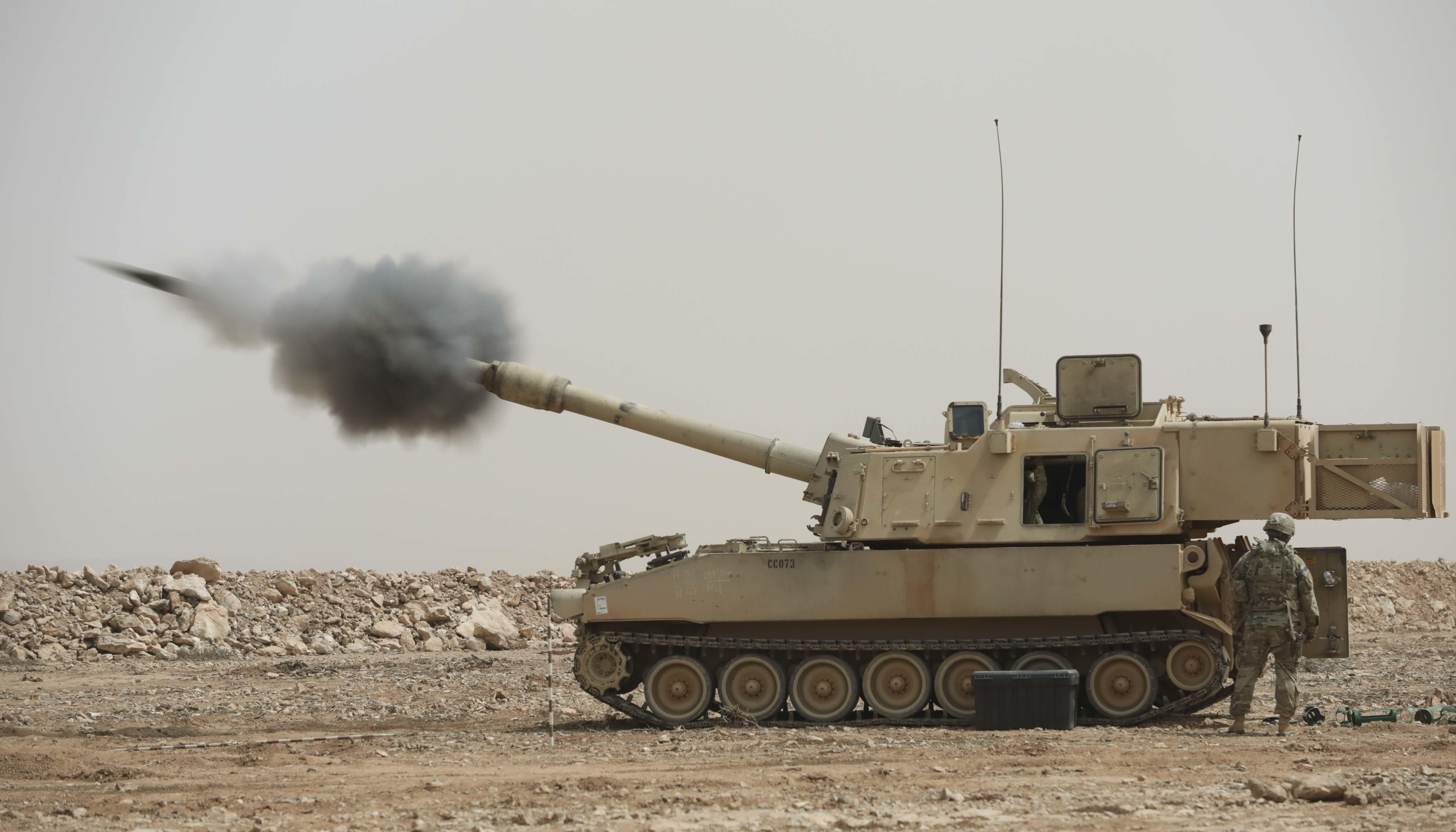 A M109A6 Paladin fires a 155mm high explosive round during Exercise