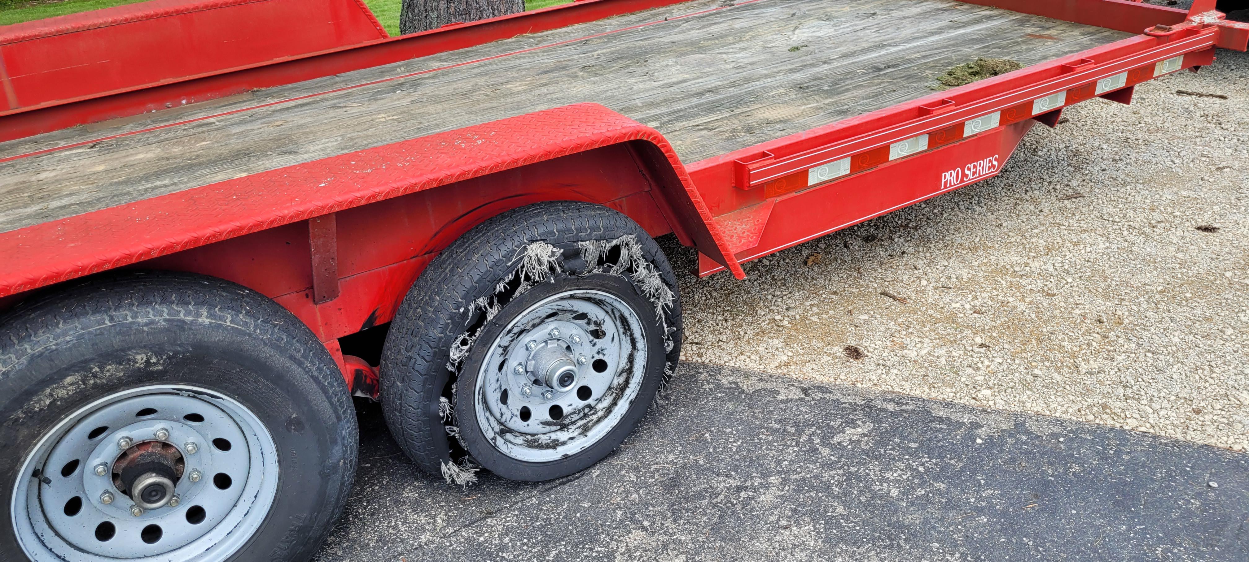 Man hole cover pop up off the road and my trailer tire popped . Some