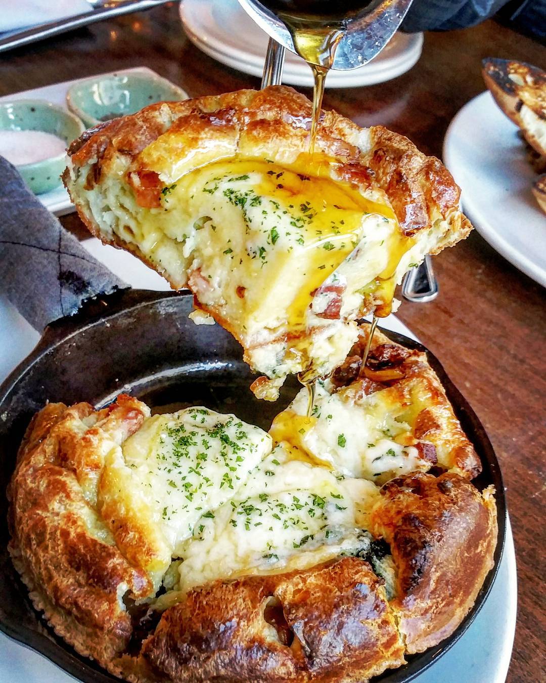 Savory dutch baby pancake with cheese, bacon, broccoli and maple syrup