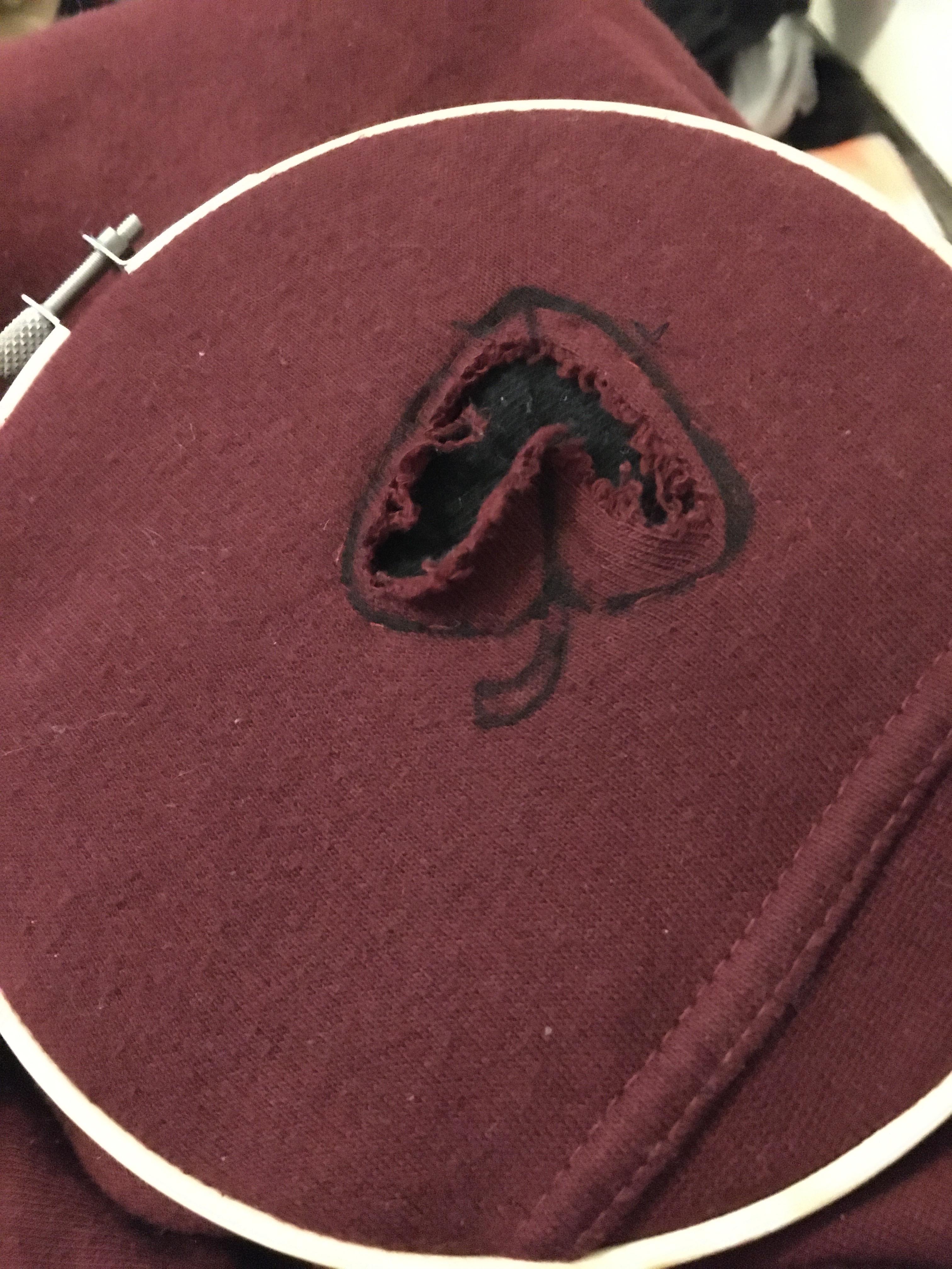 Patched up a hole in a sweater and want to embroider a leaf over it