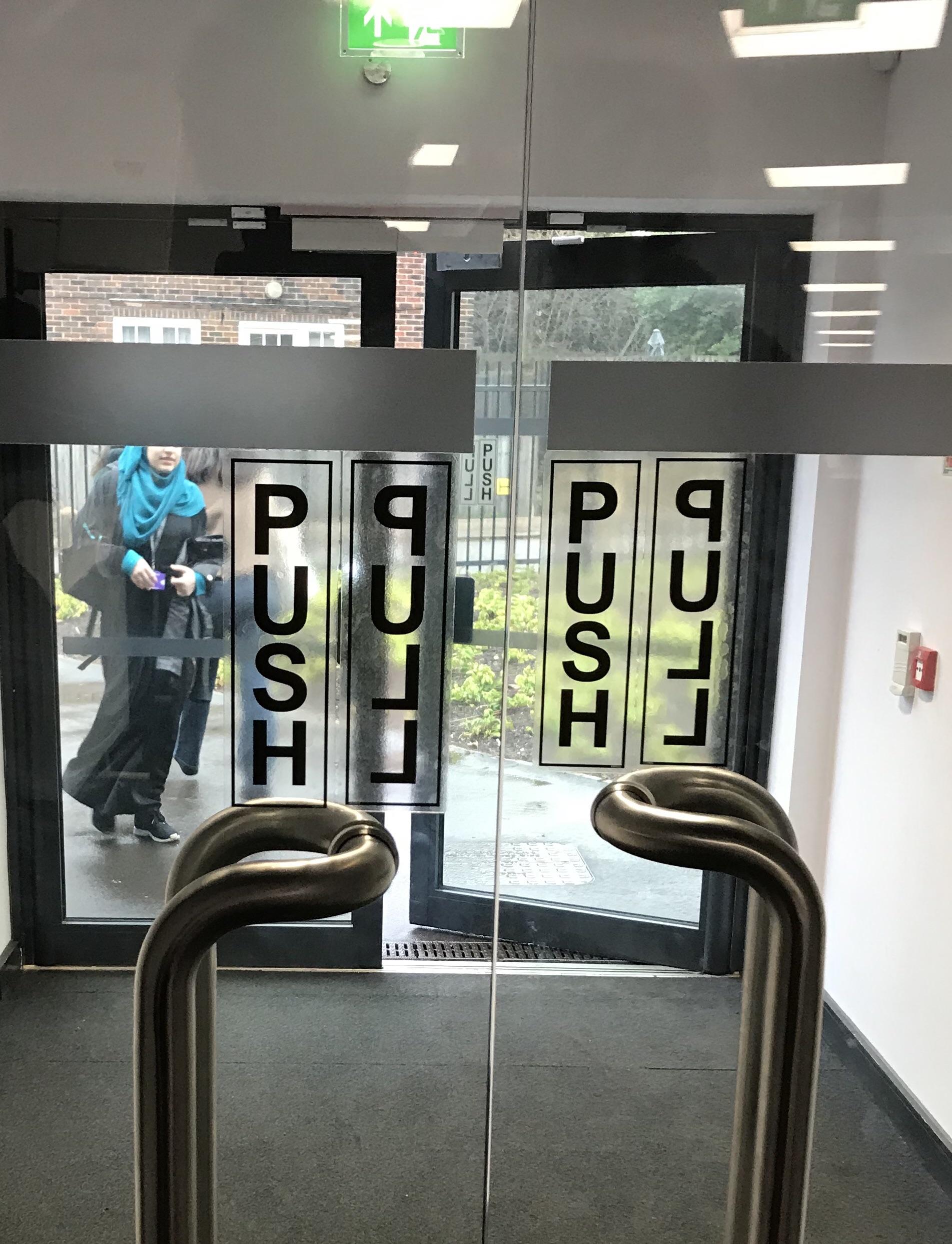 Transparent push/pull stickers on a glass door r/CrappyDesign