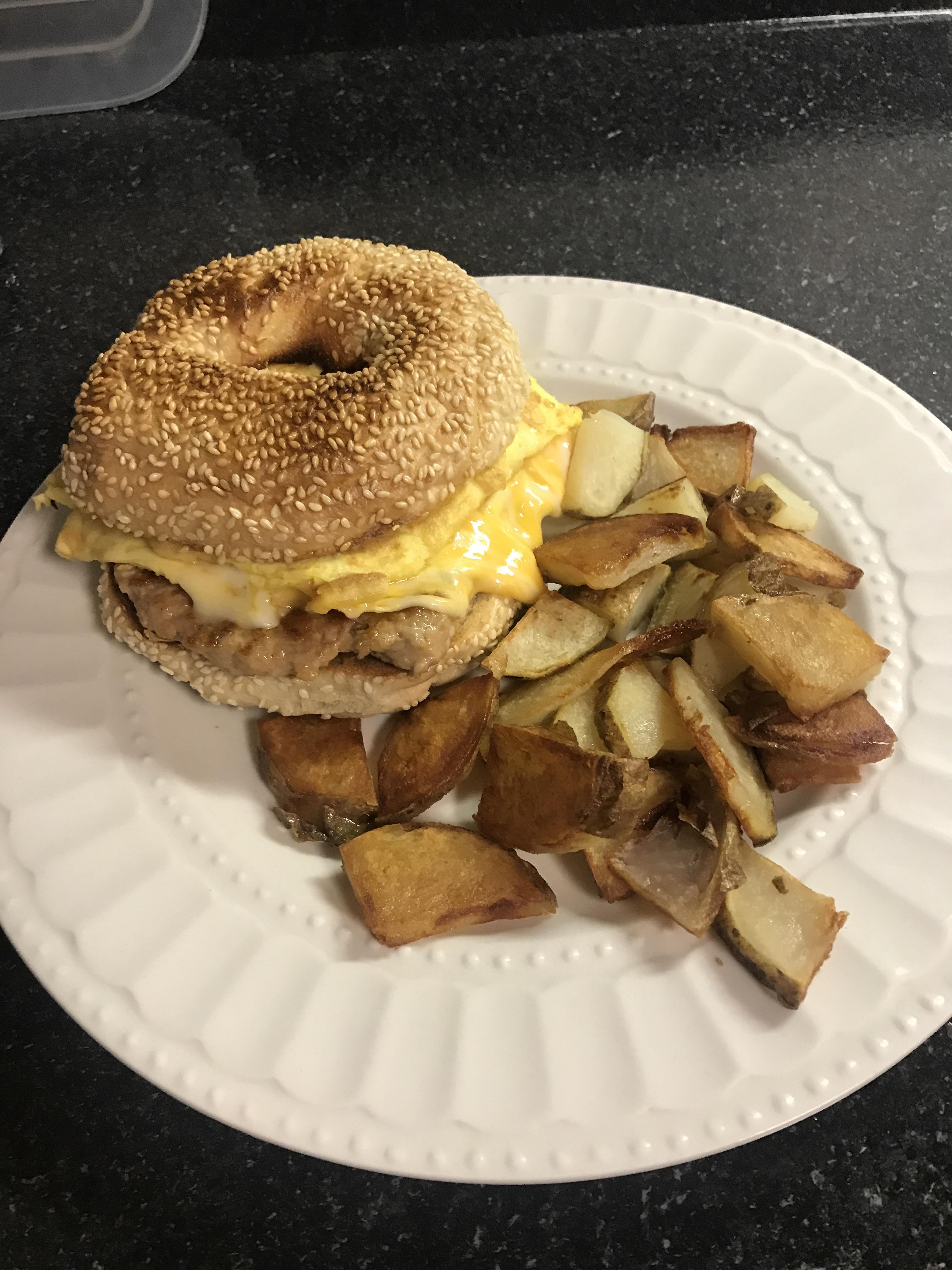 [Homemade] Sausage, Egg, and Cheese on Sesame Bagel with Fried Potatoes r/food