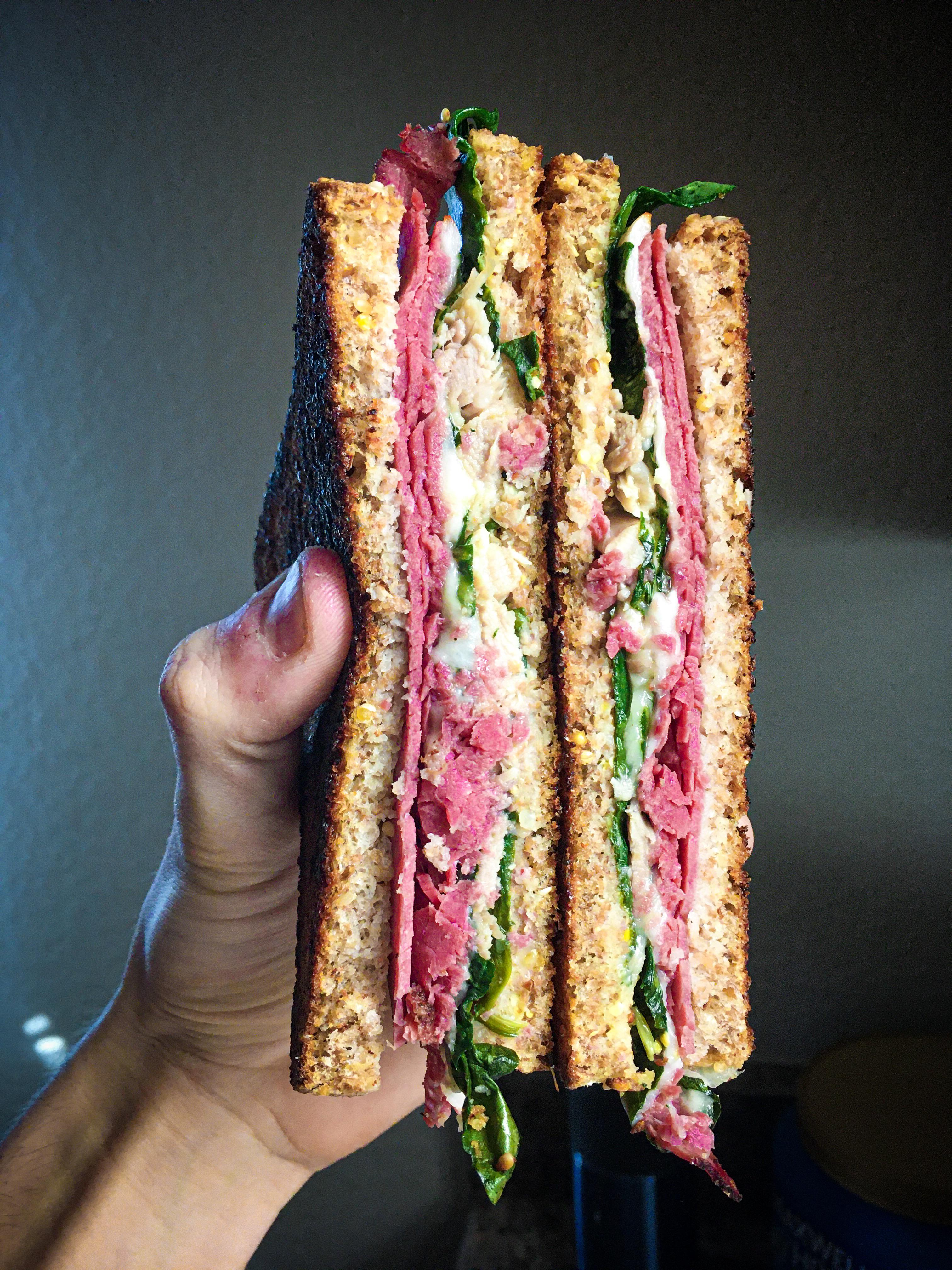 Pastrami and Turkey Sandwich with Muenster on Ezekiel Bread. r