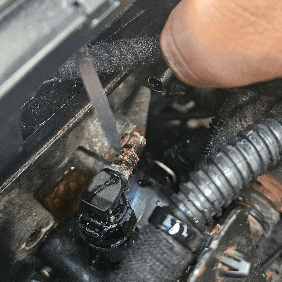 Coolant was leaking from a crack in the hose at the connection point